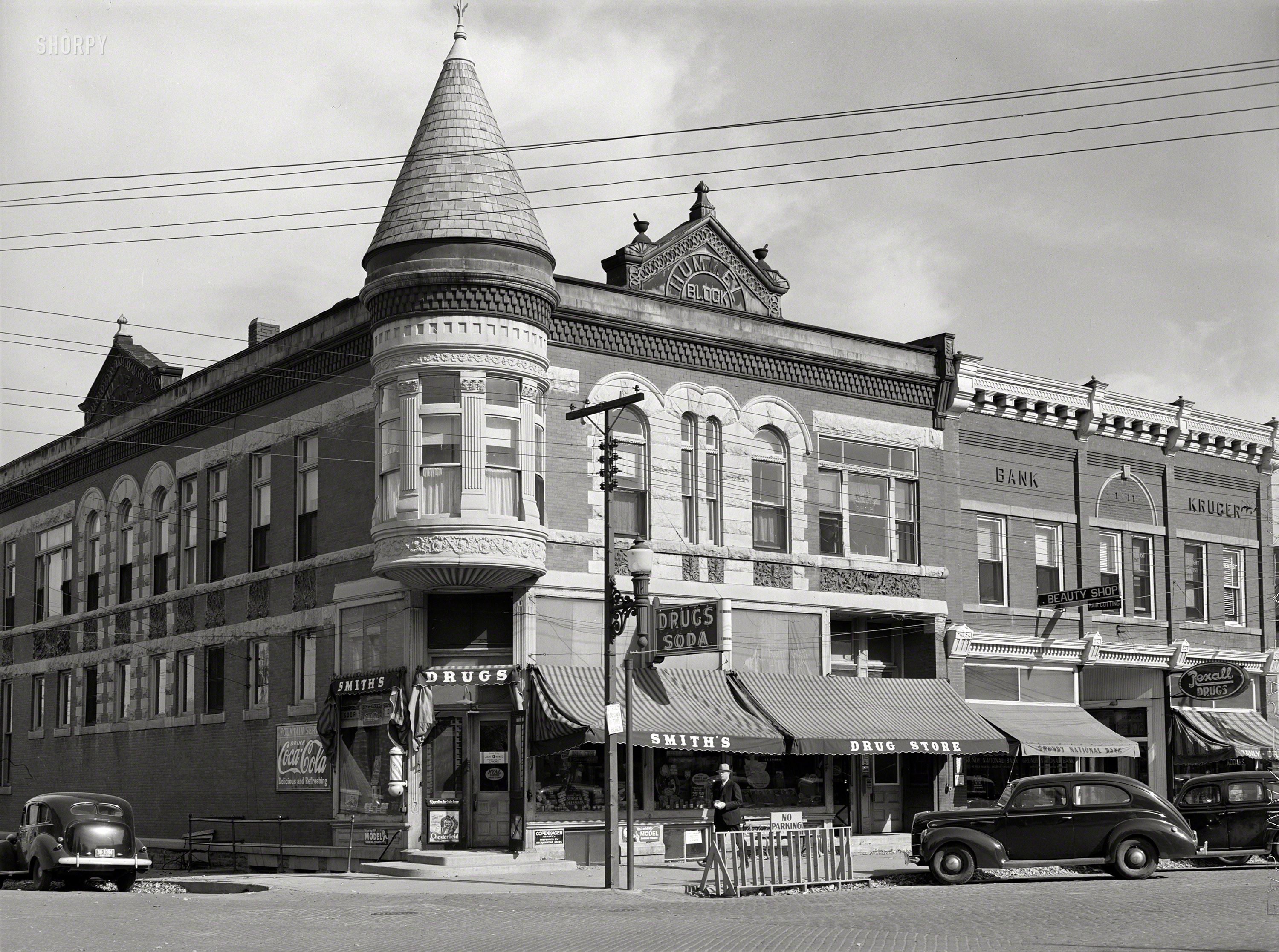October 1939. "Stores on main street (G Avenue). Grundy Center, Iowa." Photo by Arthur Rothstein for the Farm Security Administration. View full size.