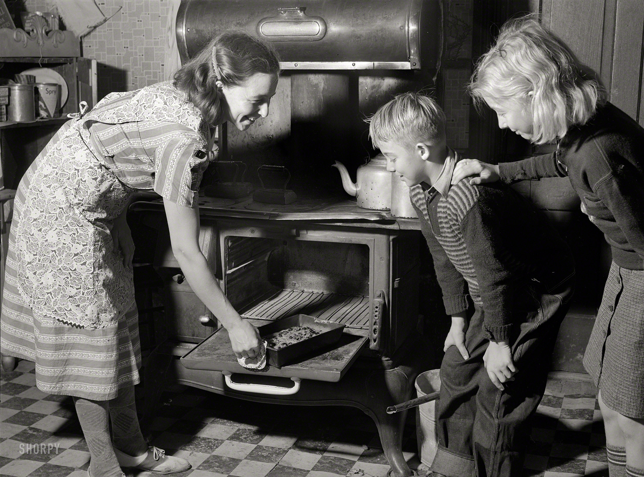 November 1939. "The FSA county home supervisor helps Mrs. Dixon [last seen here] plan a practical way of managing her household. St. Charles County, Mo." Photo by Arthur Rothstein for the Farm Security Administration. View full size.