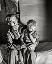 November 1939. Butler County, Missouri. "Evicted sharecropper and son. Camp of makeshift homes built by white and Negro sharecroppers evicted from plantation." Medium format acetate negative by Arthur Rothstein for the Farm Security Administration. View full size.