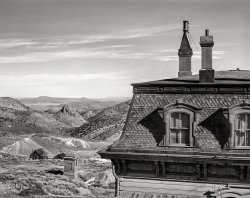 March 1940. "Corner of old mine office, abandoned mines in distance. Virginia City, Nevada." Photo by Arthur Rothstein for the FSA. View full size.