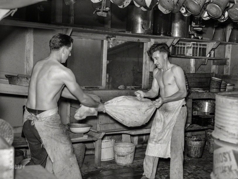 September 1937. "Cooks drying 'silverware' in logging camp near Effie, Minnesota." Medium format negative by Russell Lee. View full size.
