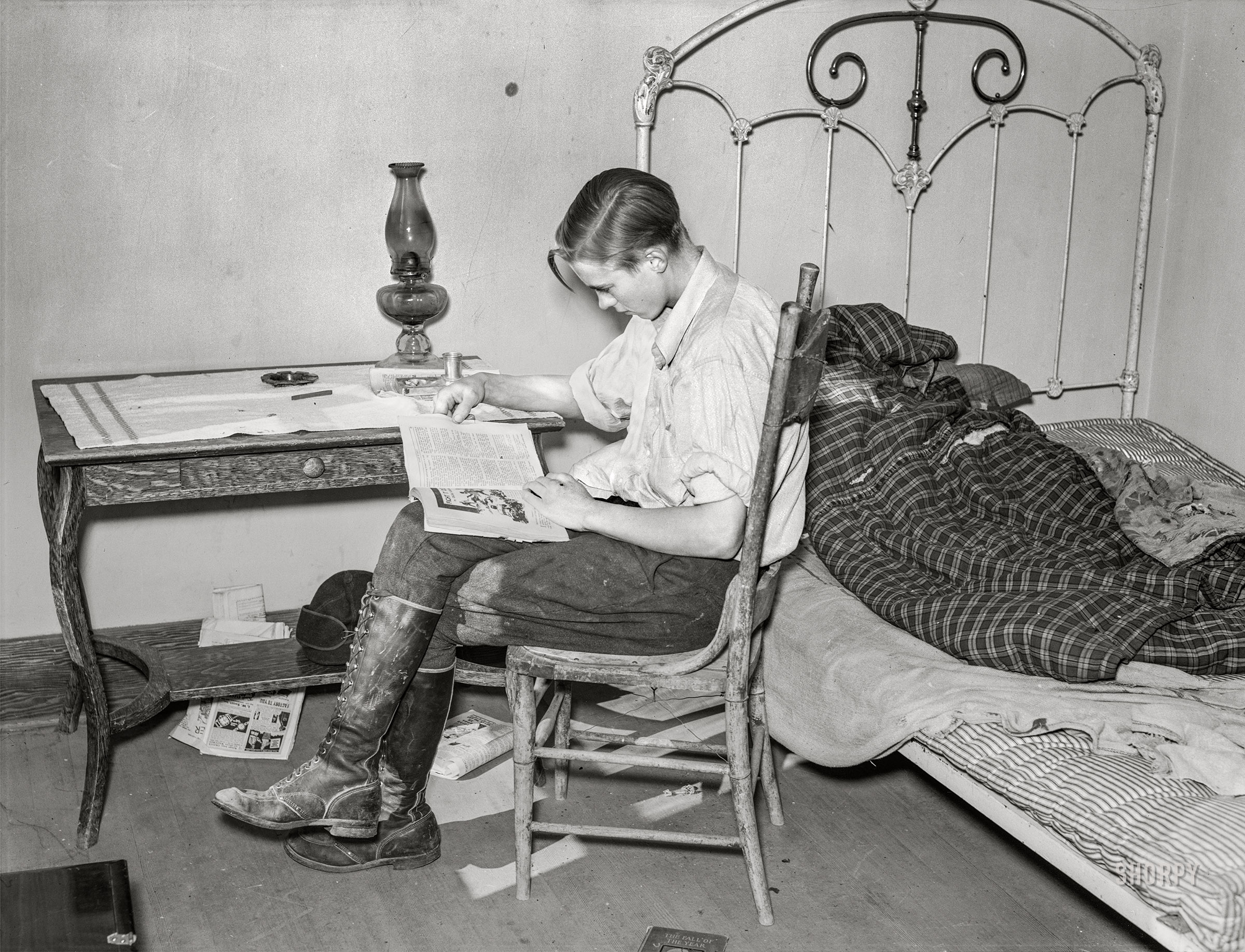 &nbsp; &nbsp; &nbsp; &nbsp; "Sure sounds like trouble," Tip muttered, frowning.
October 1937. "Boy reading in bedroom. Note lack of proper bed clothing. Home of A.O. Ryland, farmer who has quit farming. Near Williston, North Dakota." Medium format acetate negative by Russell Lee for the Farm Security Administration. View full size.