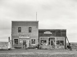 November 1937. "Store building at Alger [i.e. Archer], Sheridan County, Montana." Medium format negative by Russell Lee for the Farm Security Administration. View full size.