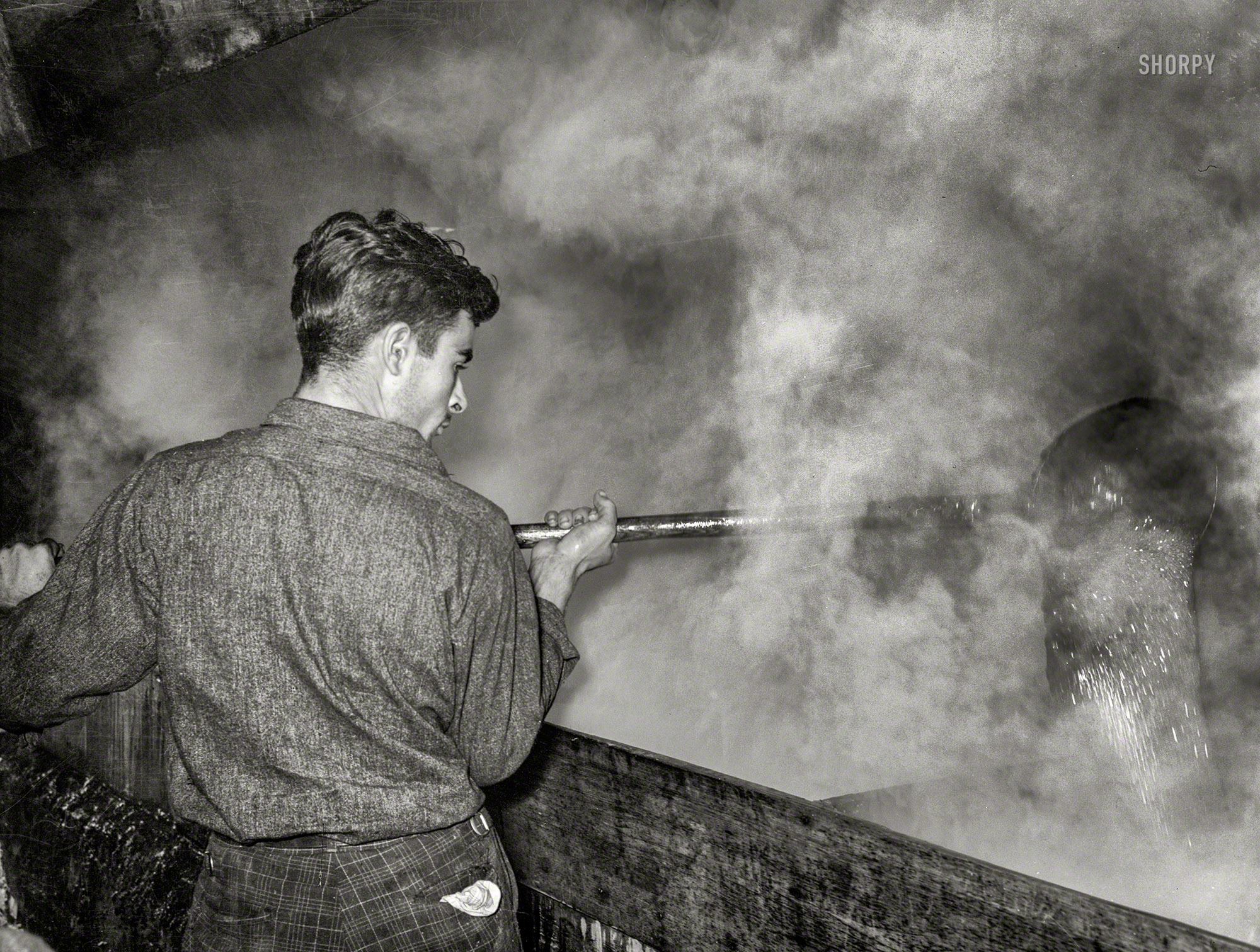 October 1938. "Ladling cane syrup from boiling vat to concentration vat at a sugar mill near New Iberia, Louisiana." Medium format acetate negative by Russell Lee for the Farm Security Administration. View full size.