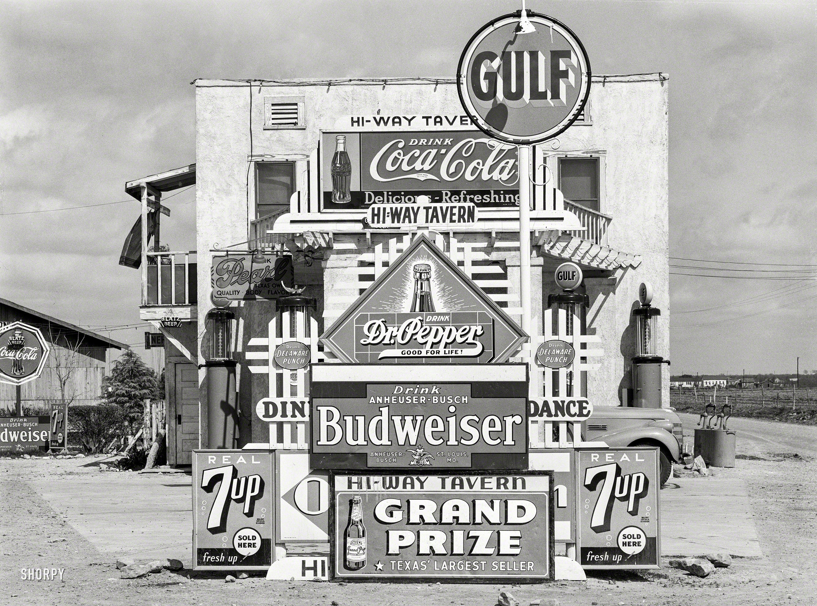 March 1939. "Signs in front of highway tavern. Crystal City, Texas." And, somewhere back there amid the signage, a gas station. Medium format acetate negative by Russell Lee for the Farm Security Administration. View full size.