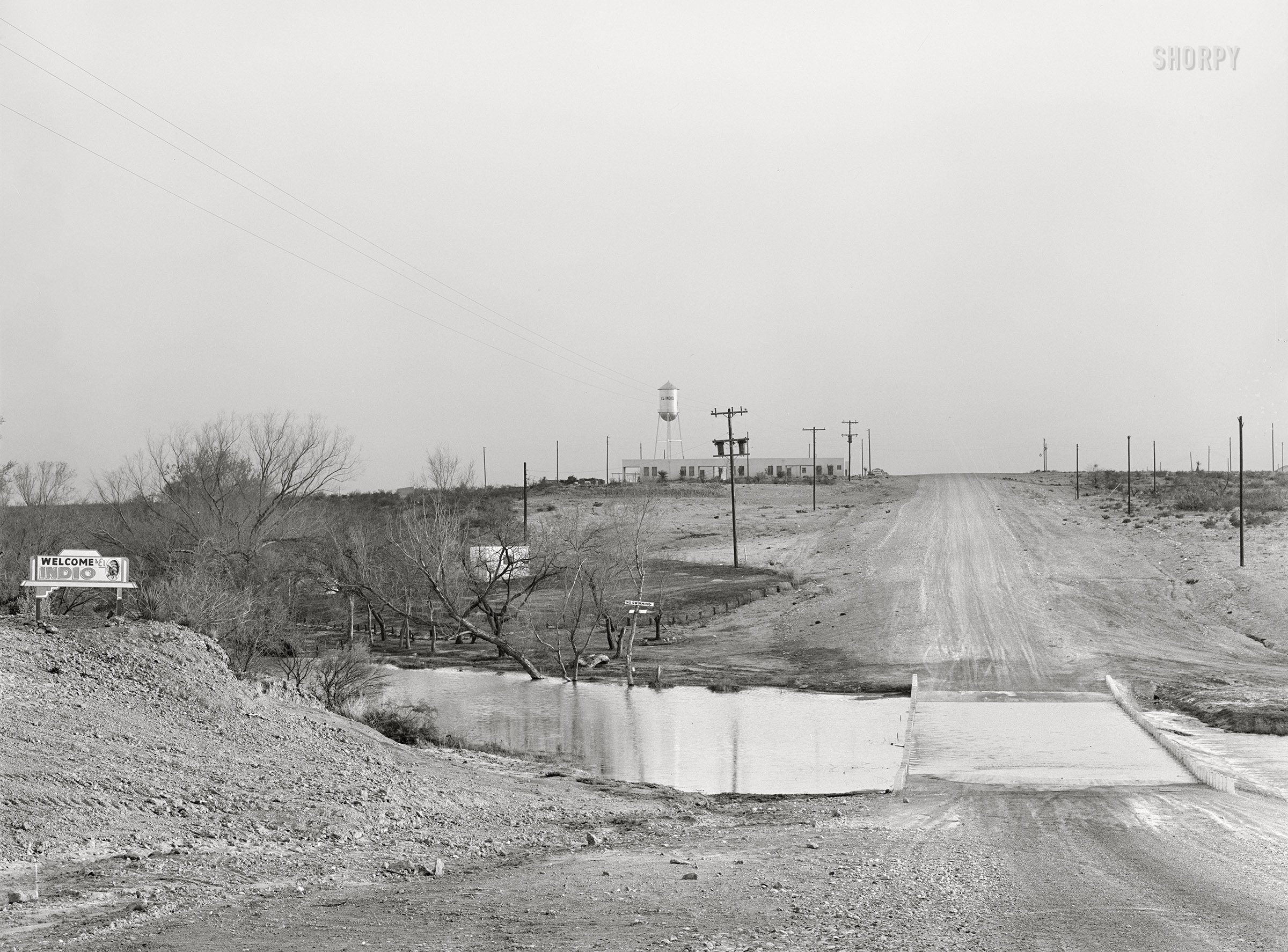 March 1939. "Approach to El Indio, Texas." Welcome, but NO SWIMMING. Medium format acetate negative by Russell Lee for the Farm Security Administration. View full size.