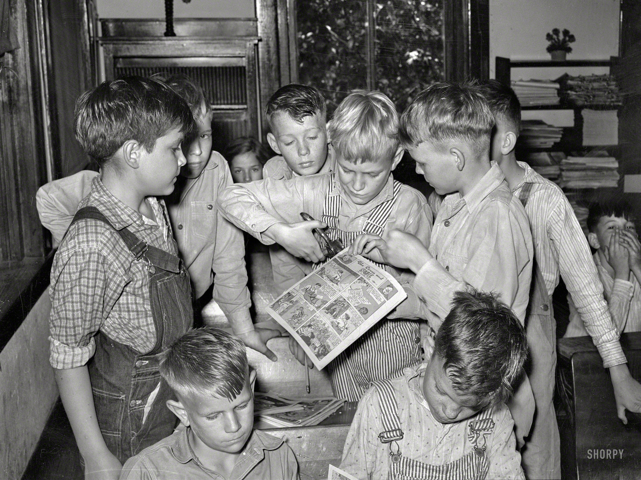&nbsp; &nbsp; &nbsp; &nbsp; The comic: "The Circus and Sue," by Claire S. Moe.
April 1939. San Augustine, Texas. "Grade-school boys making books of comic strips." Photo by Russell Lee, Farm Security Administration. View full size.