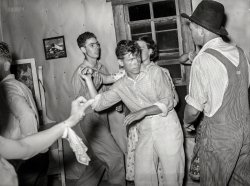 July 1939. "Detail of square dance in hills near McAlester, Pittsburg County, Oklahoma. Sharecropper's home." Medium format acetate negative by Russell Lee for the Farm Security Administration. View full size.
Osh Kosh B&#039; GoshGet out your best overalls and cut a rug.
Sweat lodgeIn July in Oklahoma the temp is almost always in the triple digits and it seems like it would be stifling to be crammed into a sharecropper's tiny home with only a window slightly open for air and of course no a/c, with everybody dancing madly.  I find the African American art on the wall of interest also.
[Tell us more about that art. - Dave]
(The Gallery, Russell Lee)