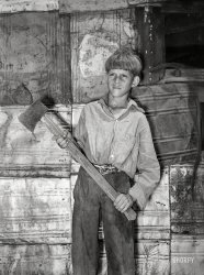 July 1939. "Oklahoma City. Boy living in May Avenue camp with homemade ax." Photo by Russell Lee for the Farm Security Administration. View full size.