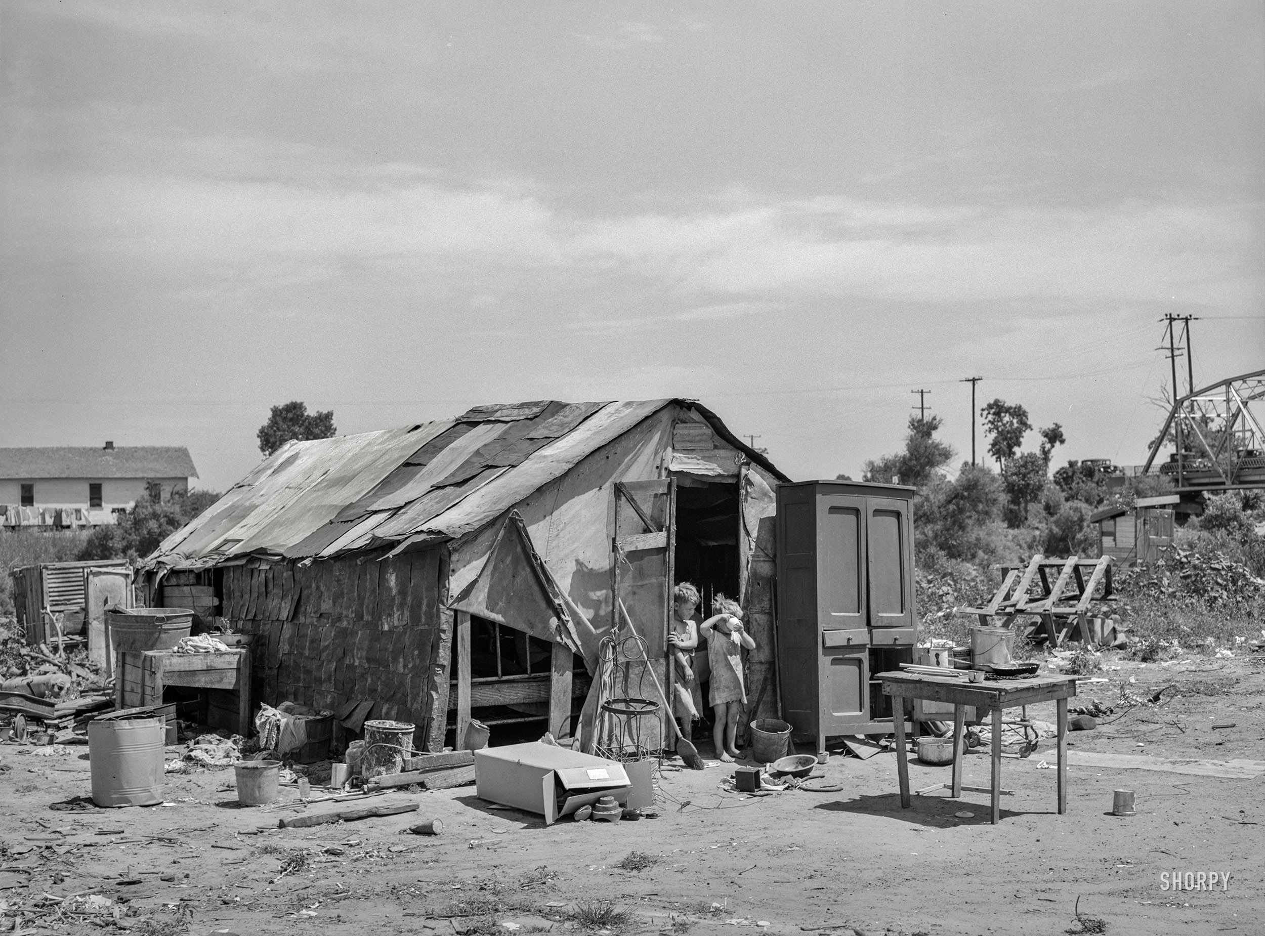 July 1939. "Shack of family living in May Avenue camp, Oklahoma City." Photo by Russell Lee for the Farm Security Administration. View full size.
