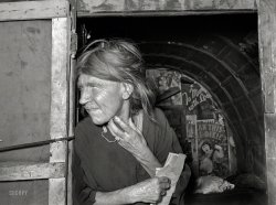 July 1939. "Woman living in camp near May Avenue, Oklahoma City. Her husband has been denied work relief. He is a world war veteran." Medium format negative by Russell Lee for the Farm Security Administration. View full size.