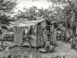 July 1939. "Tent home of family living in community camp. Oklahoma City." Photo by Russell Lee for the Farm Security Administration. View full size.