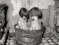 July 1939. Oklahoma City. "Children taking bath in their home in May Avenue community camp." Medium format negative by Russell Lee. View full size.