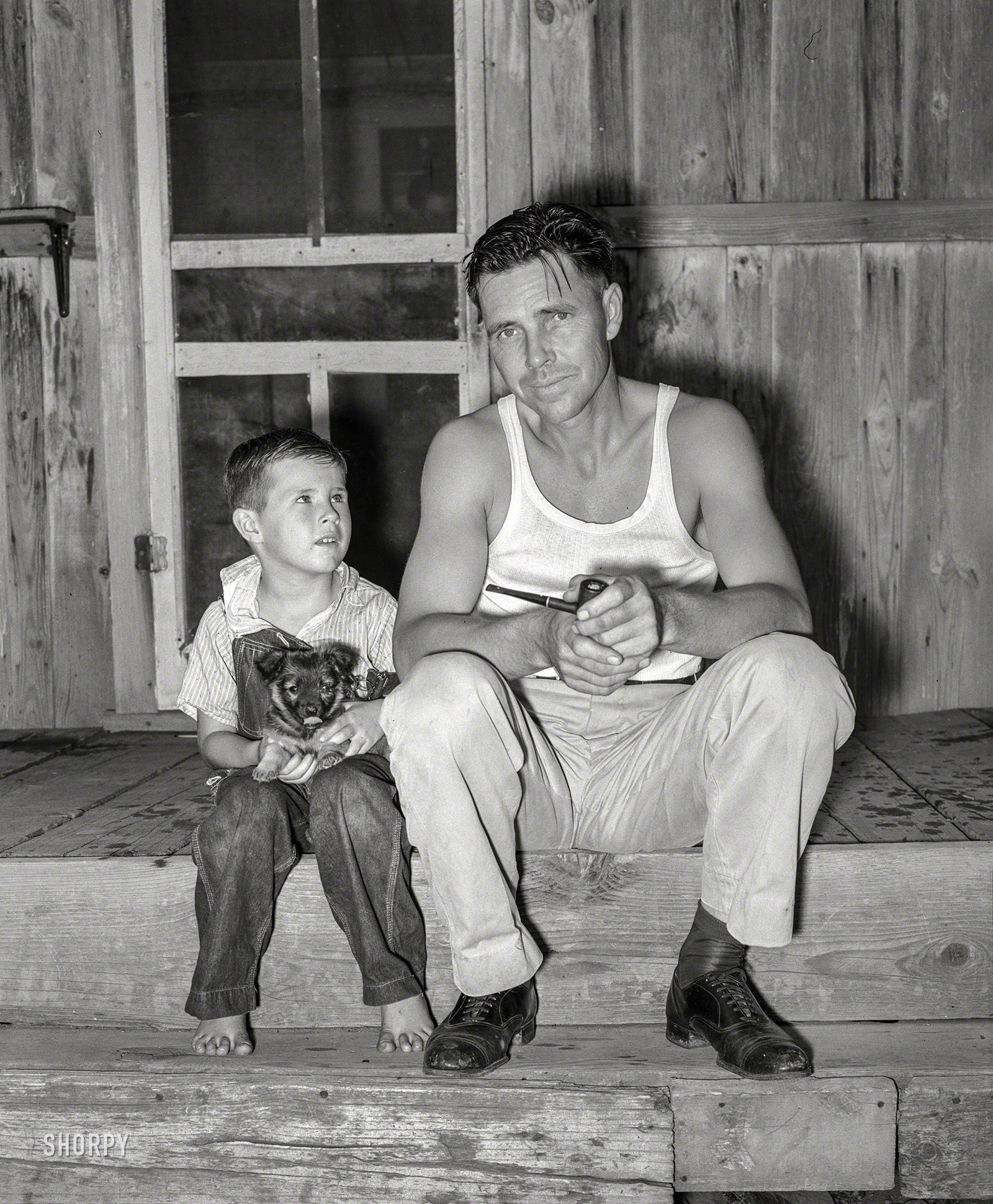 August 1939. "Oilfield truck driver and his son sitting on front porch. Seminole, Oklahoma." Happy Father's Day from Shorpy! Medium format negative by Russell Lee for the Farm Security Administration. View full size.