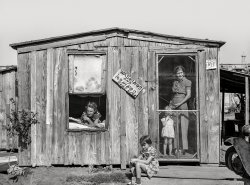 August 1939. "Home and family of oil field roustabout in Oklahoma City. During periods of unemployment the woman takes in washing and ironing." Photo by Russell Lee for the Farm Security Administration. View full size.