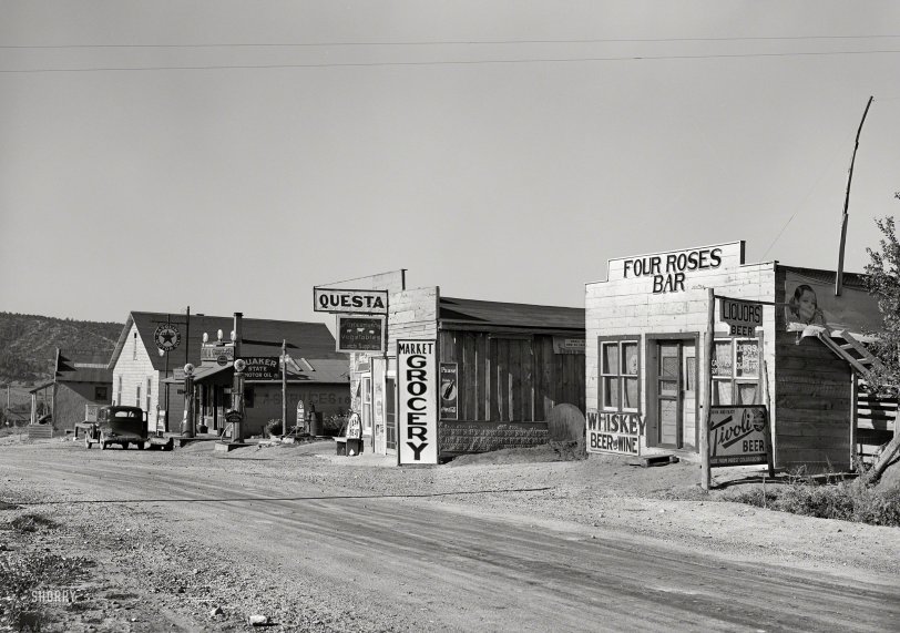 September 1939. "Street scene. Questa, New Mexico." One last look at the business district of this bucolic burg before we motor west. Medium format acetate negative by Russell Lee for the Farm Security Administration. View full size.
