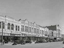 November 1939. "Scene in the business section of Gonzales, Texas." Medium format acetate negative by Russell Lee for the Farm Security Administration. View full size.