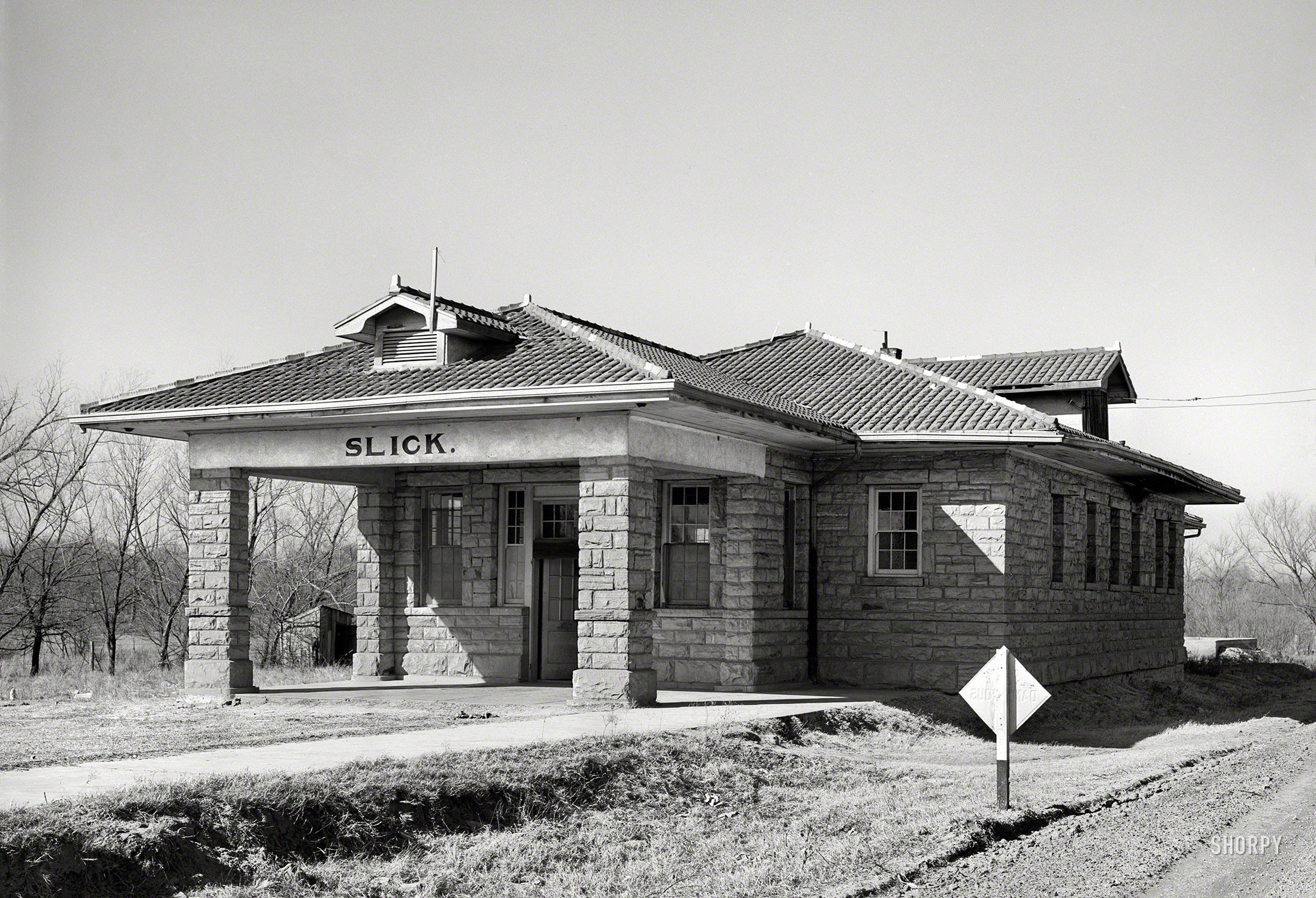 February 1940. "Abandoned railway station, now used as a church, in the oil ghost town of Slick, Oklahoma." Medium format acetate negative by Russell Lee for the Farm Security Administration. View full size.