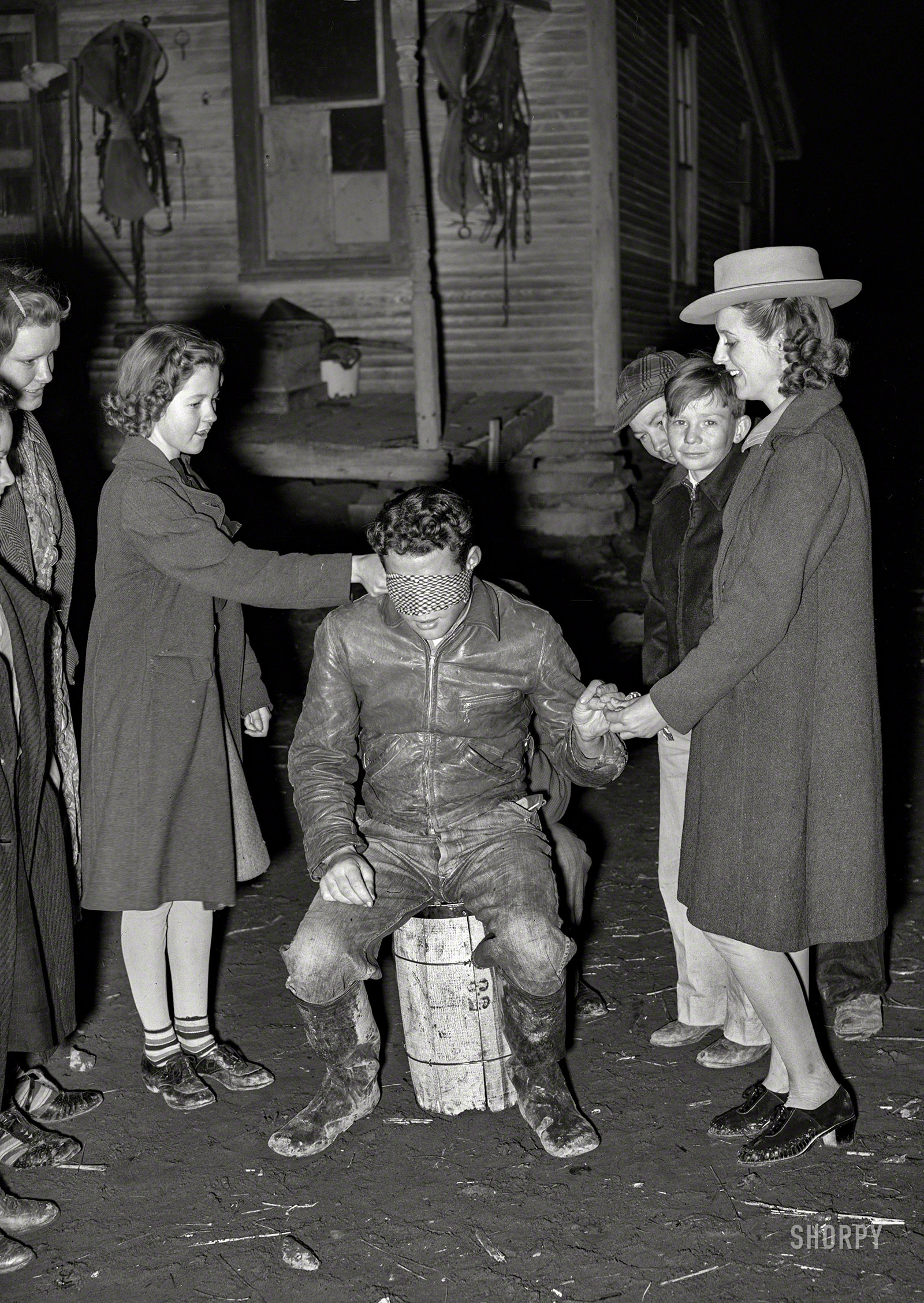 February 1940. "Playing the game 'Fishing for Love' at a 'play party' in McIntosh County, Oklahoma." When your parents think you're at "4-H" meeting. Photo by Russell Lee for the Farm Security Administration, wink wink. View full size.