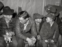 February 1940. "Farm boys at 'play party' in McIntosh County, Oklahoma." Photo by Russell Lee for the Farm Security Administration. View full size.