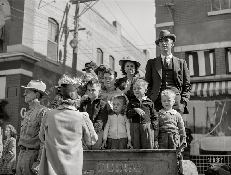 March 1940. San Angelo, Texas. "Watching the parade which opened the Fat Stock Show." Acetate negative by Russell Lee for the Farm Security Administration. View full size.
