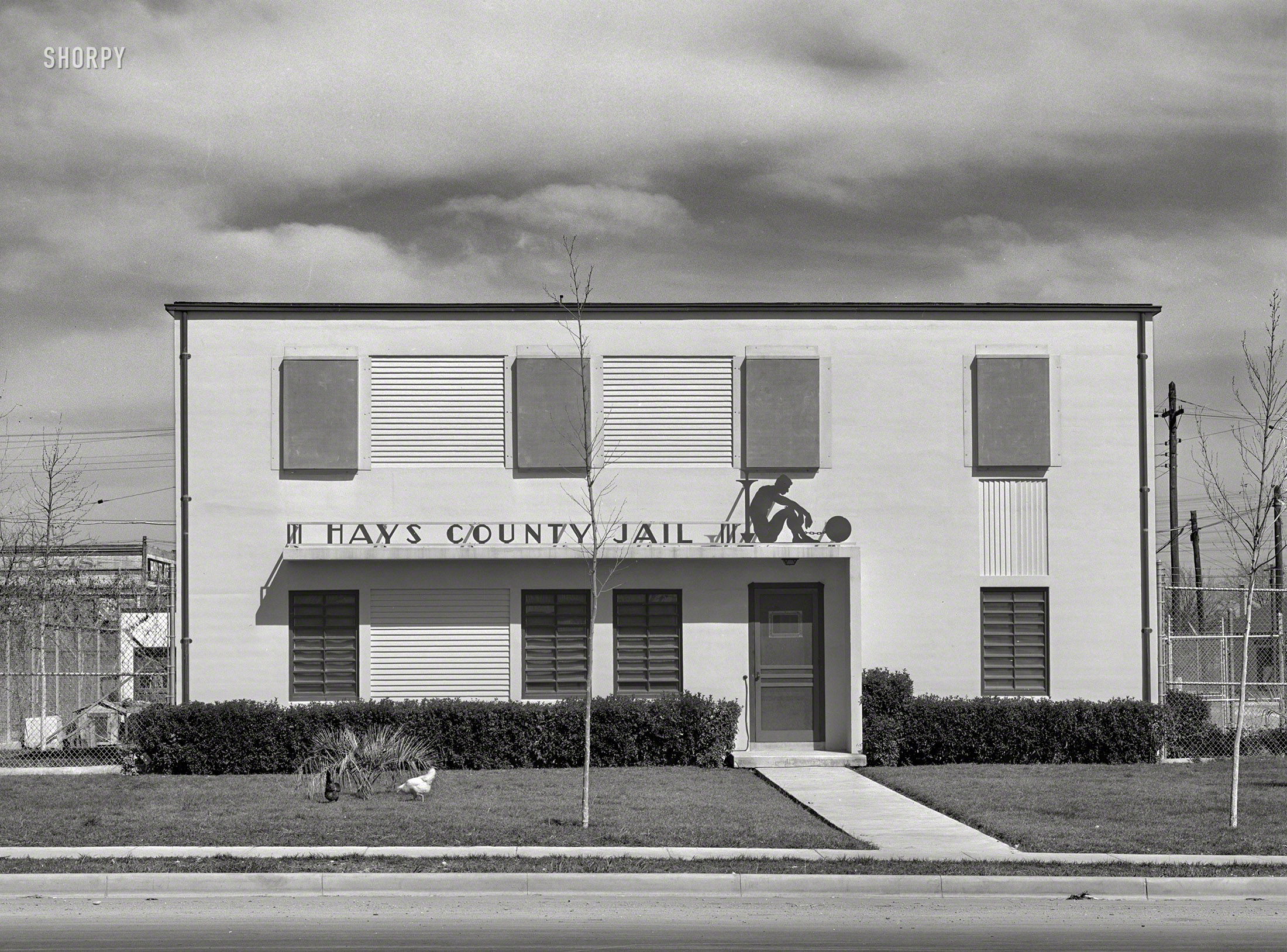 March 1940. "Hays County Jail, San Marcos, Texas. Living quarters for the Deputy Sheriff, who is the jailer, and his family, are downstairs. Jail cells are on second floor. Maid who came to the door said, 'It's the nicest place I ever saw'." Medium format negative by Russell Lee for the Farm Security Admini. View full size.