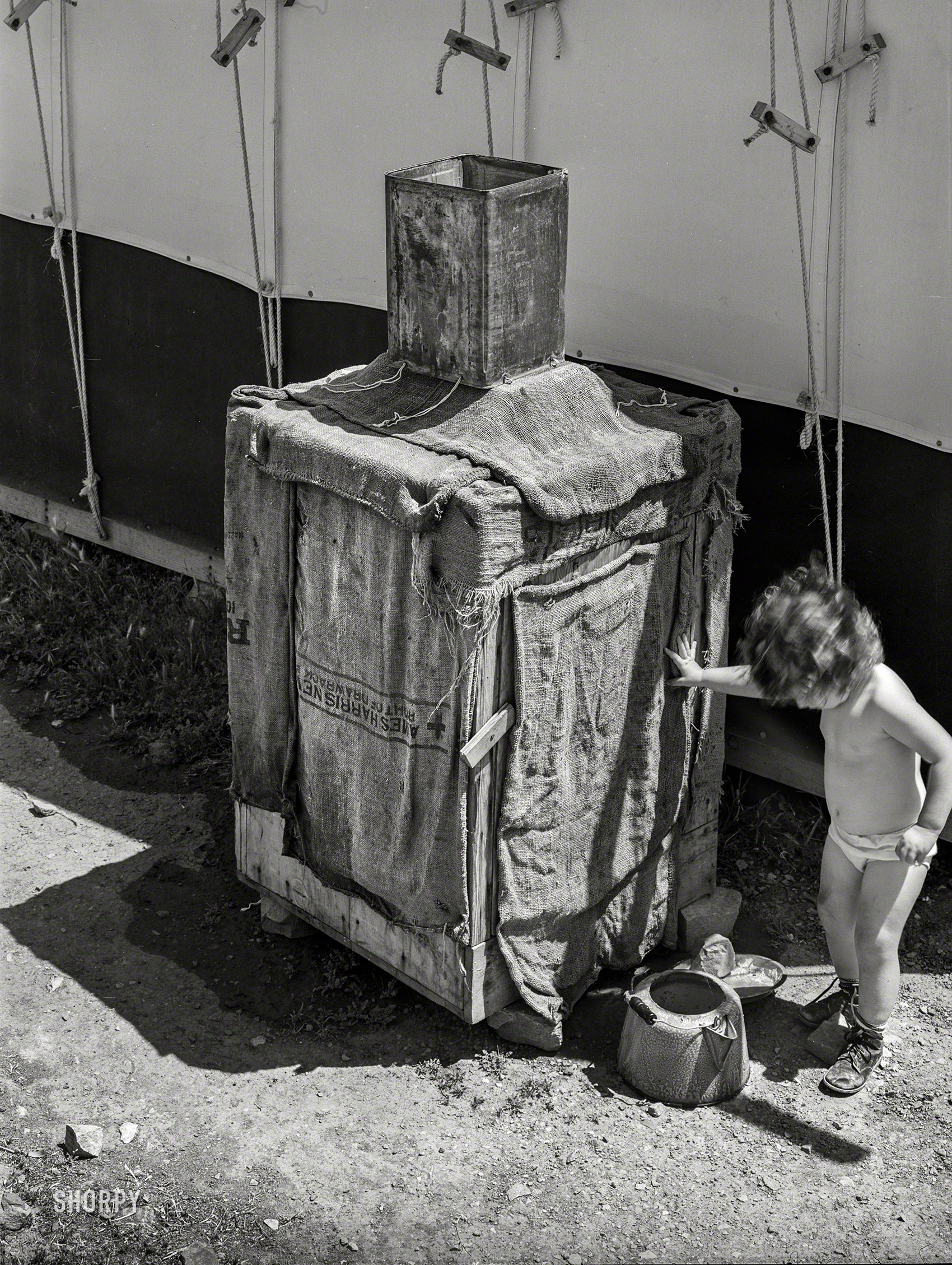 April 1940. " 'Mormon refrigerator' used by caretaker at Tonto National Monument, Gila County, Arizona. Water placed in tin container on top drips over the burlap and rapid evaporation in the atmosphere produces the cooling effect." Photo by Russell Lee for the Farm Security Administration. View full size.