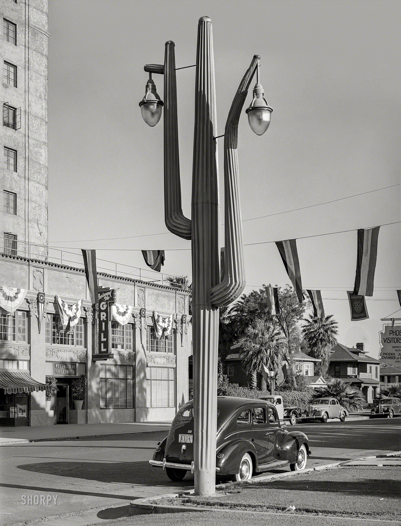 May 1940. "Cactus light standard in front of hotel in Phoenix, Arizona." Behold the Urban Saguaro. Medium format negative by Russell Lee. View full size.