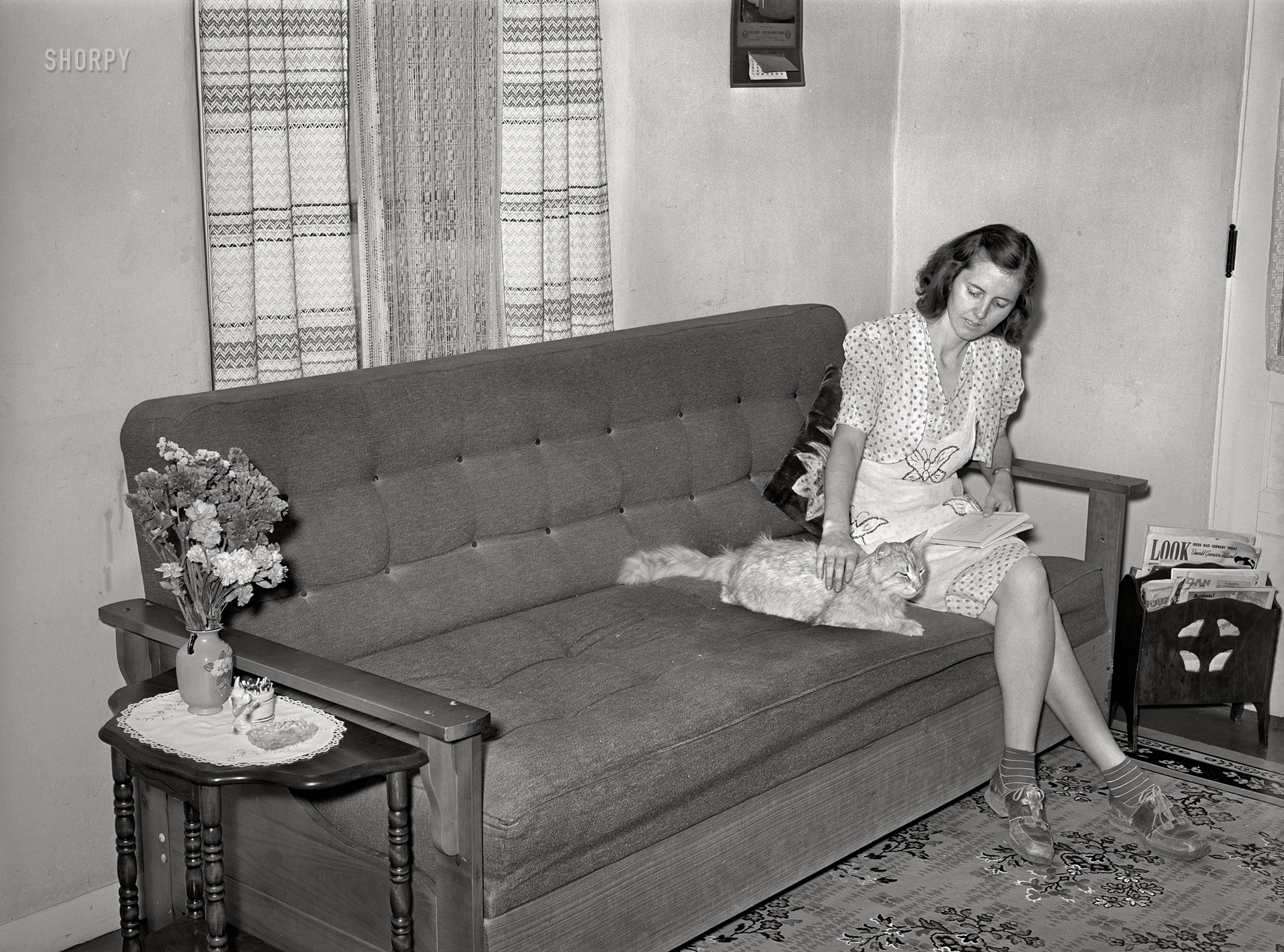 May 1940. "Wife of member of Casa Grande Valley Farms in corner of their living room. Pinal County, Arizona." Photo by Russell Lee for the Farm Security Administration. View full size.