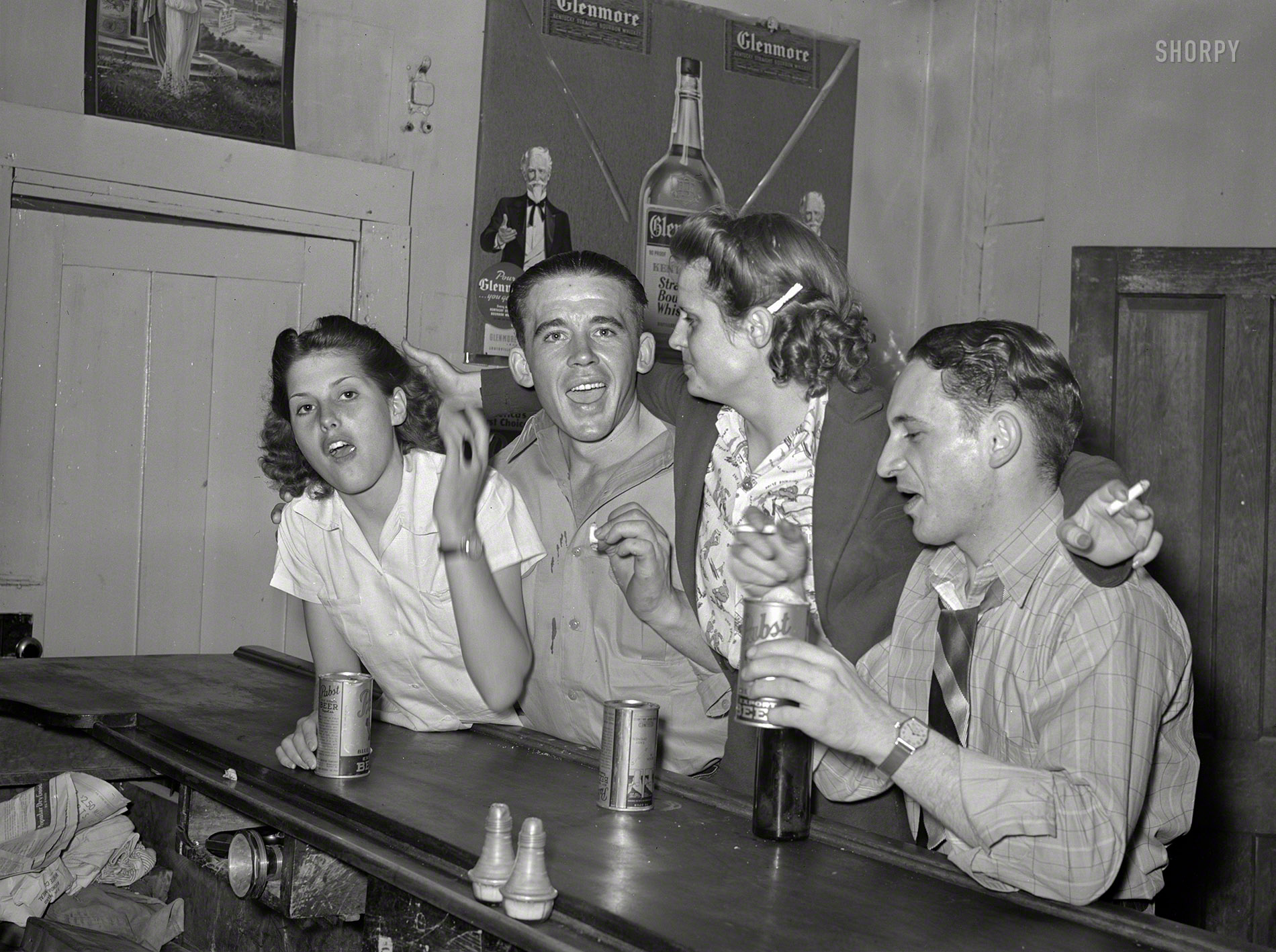 June 1940. "Youngsters in a bar at Mogollon, New Mexico." Medium format negative by Russell Lee for the Farm Security Administration. View full size.