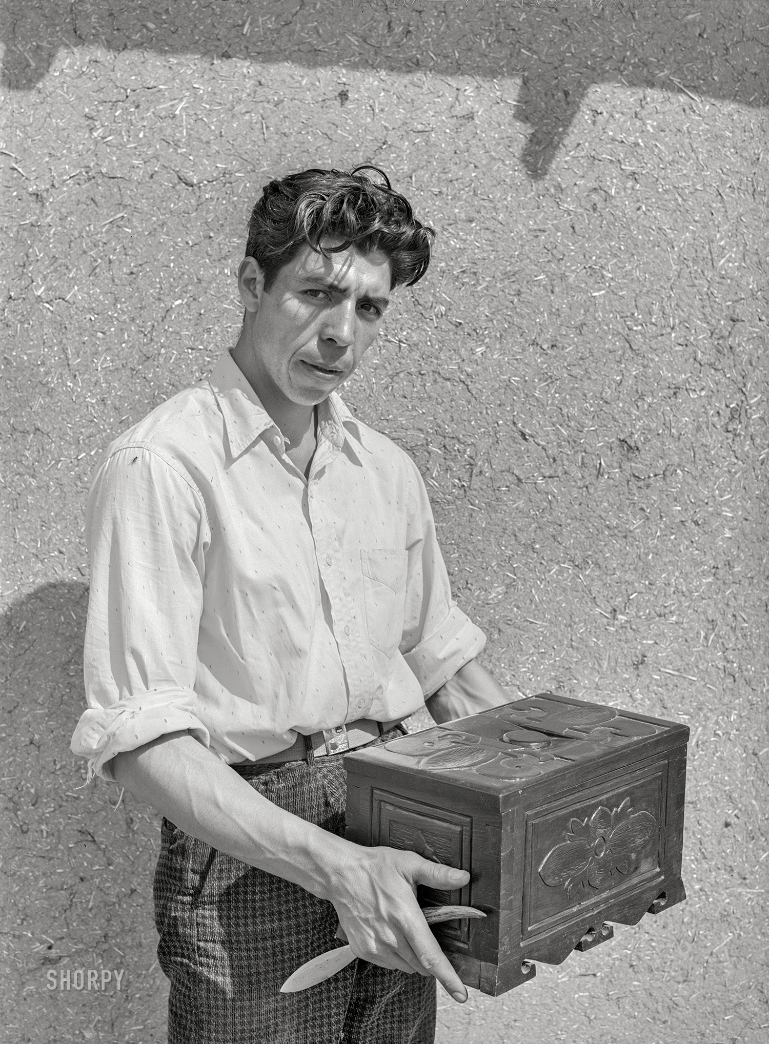 July 1940. "Chamisal, New Mexico. Spanish-American boy with chest which he carved. These people are adept in many of the handcrafts." Acetate negative by Russell Lee. View full size.