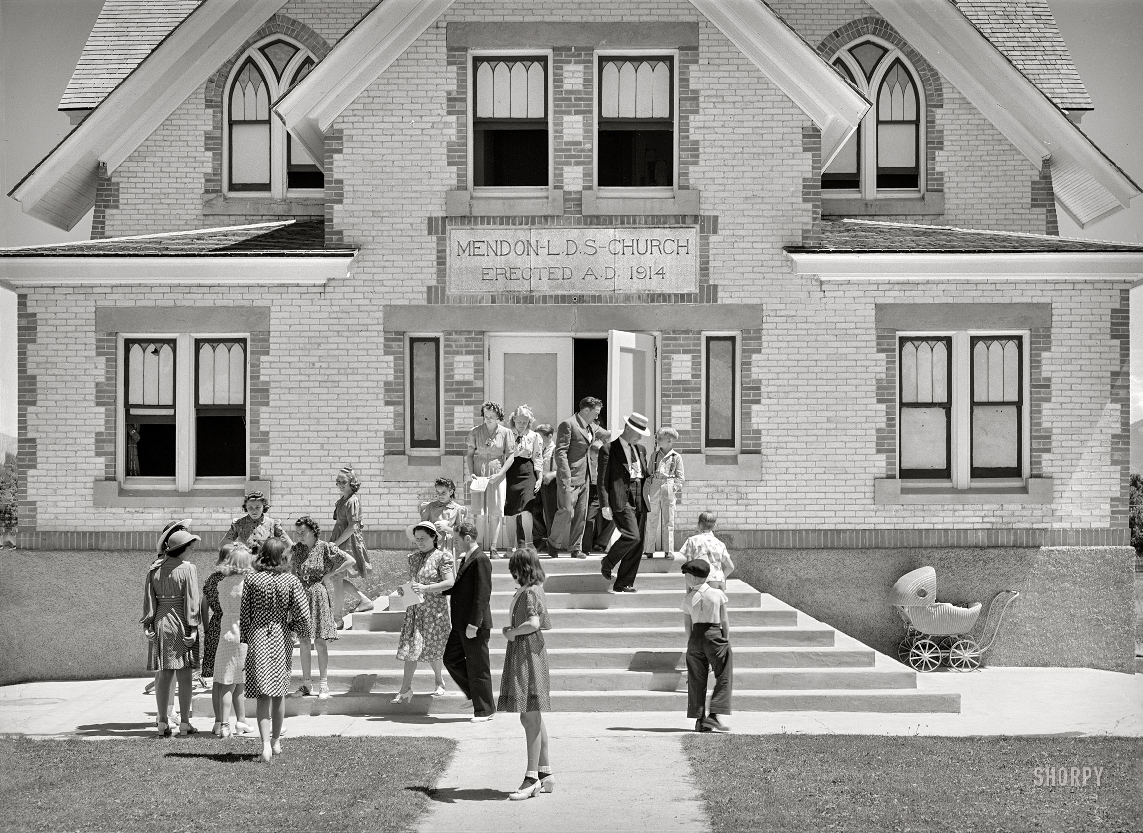 August 1940. "Congregation leaving the Latter Days Saints Church at Mendon, Cache County, Utah." Acetate negative by Russell Lee for the Farm Security Administration. View full size.
