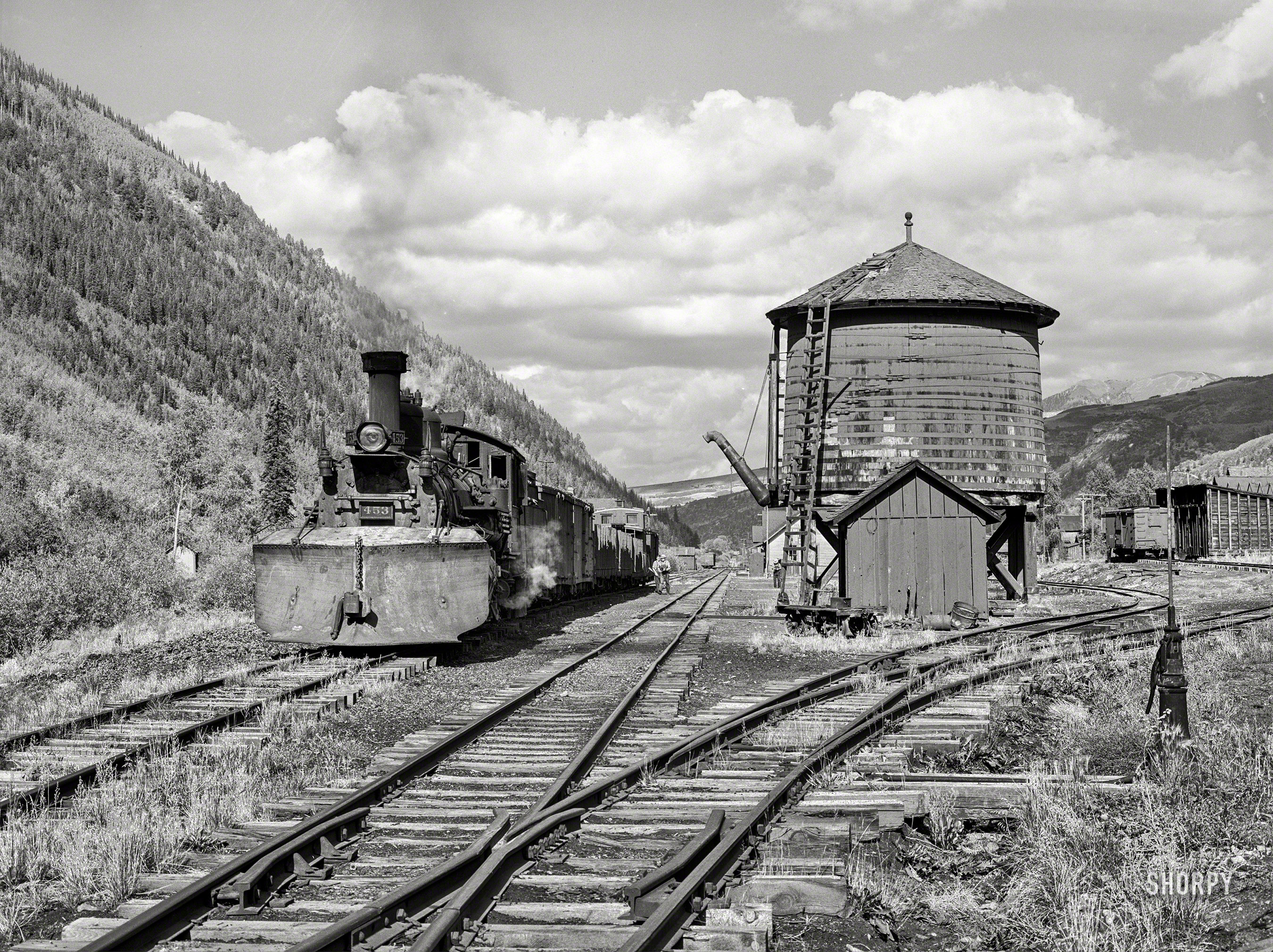 September 1940. "Narrow gauge railway yards, train and water tank at Telluride, Colorado." Medium format negative by Russell Lee for the Farm Security Administration. View full size.
