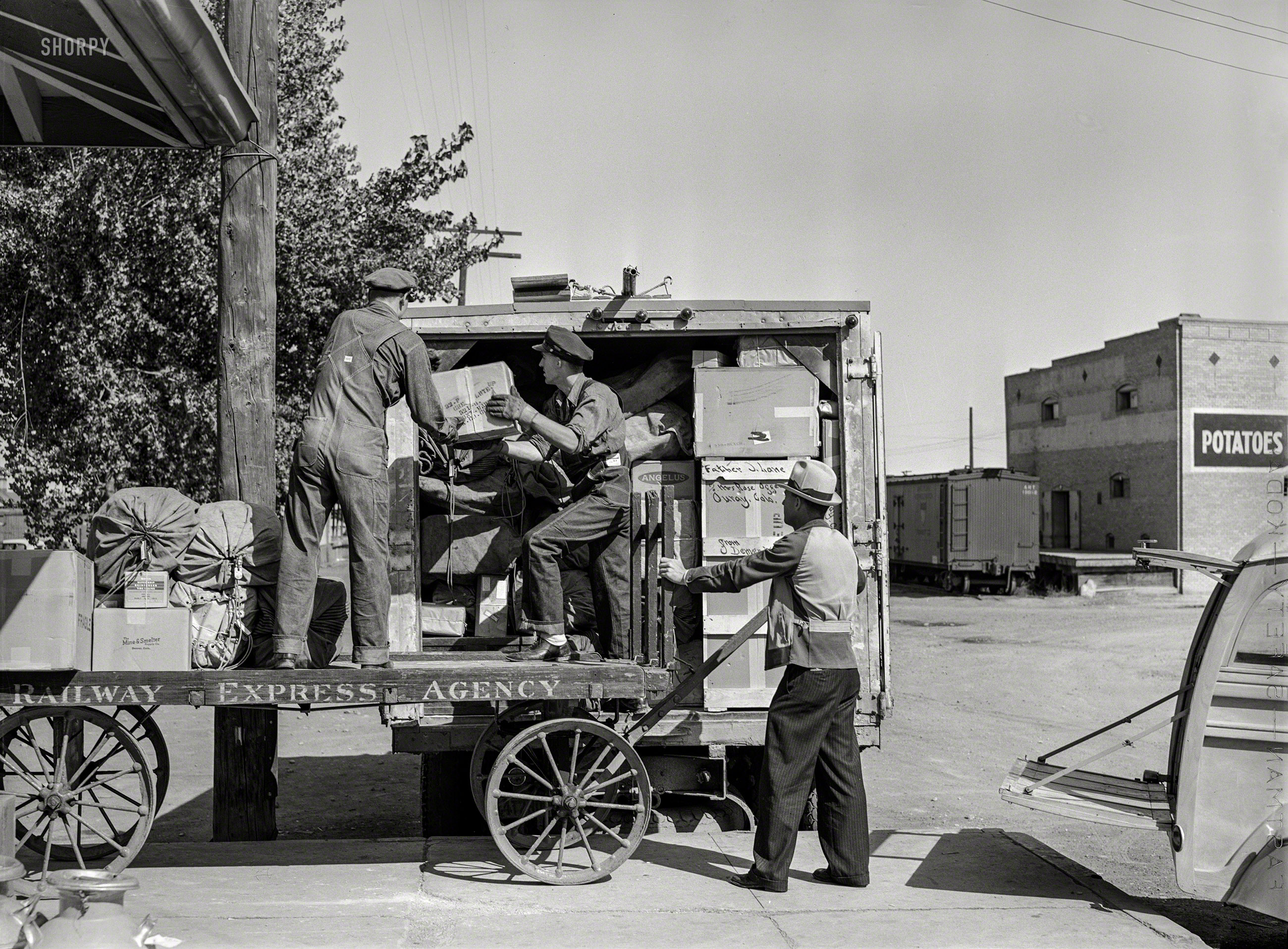 September 1940. Montrose, Colorado. "Loading express packages into Denver & Rio Grande Western truck, which takes them to points on the narrow gauge railroad where passenger and express service is not otherwise available." Acetate negative by Russell Lee for the Farm Security Administration. View full size.