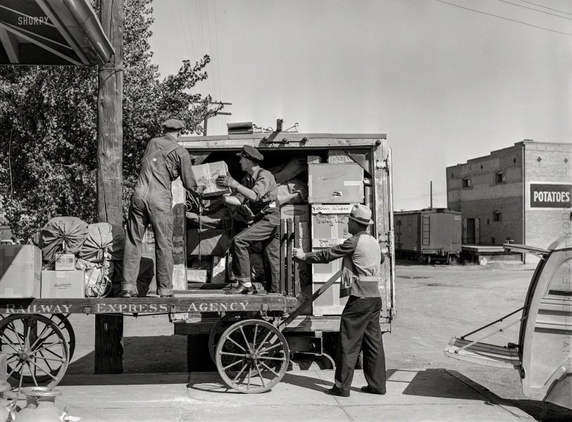 September 1940. Montrose, Colorado. "Loading express packages into Denver &amp; Rio Grande Western truck, which takes them to points on the narrow gauge railroad where passenger and express service is not otherwise available." Acetate negative by Russell Lee for the Farm Security Administration. View full size.
