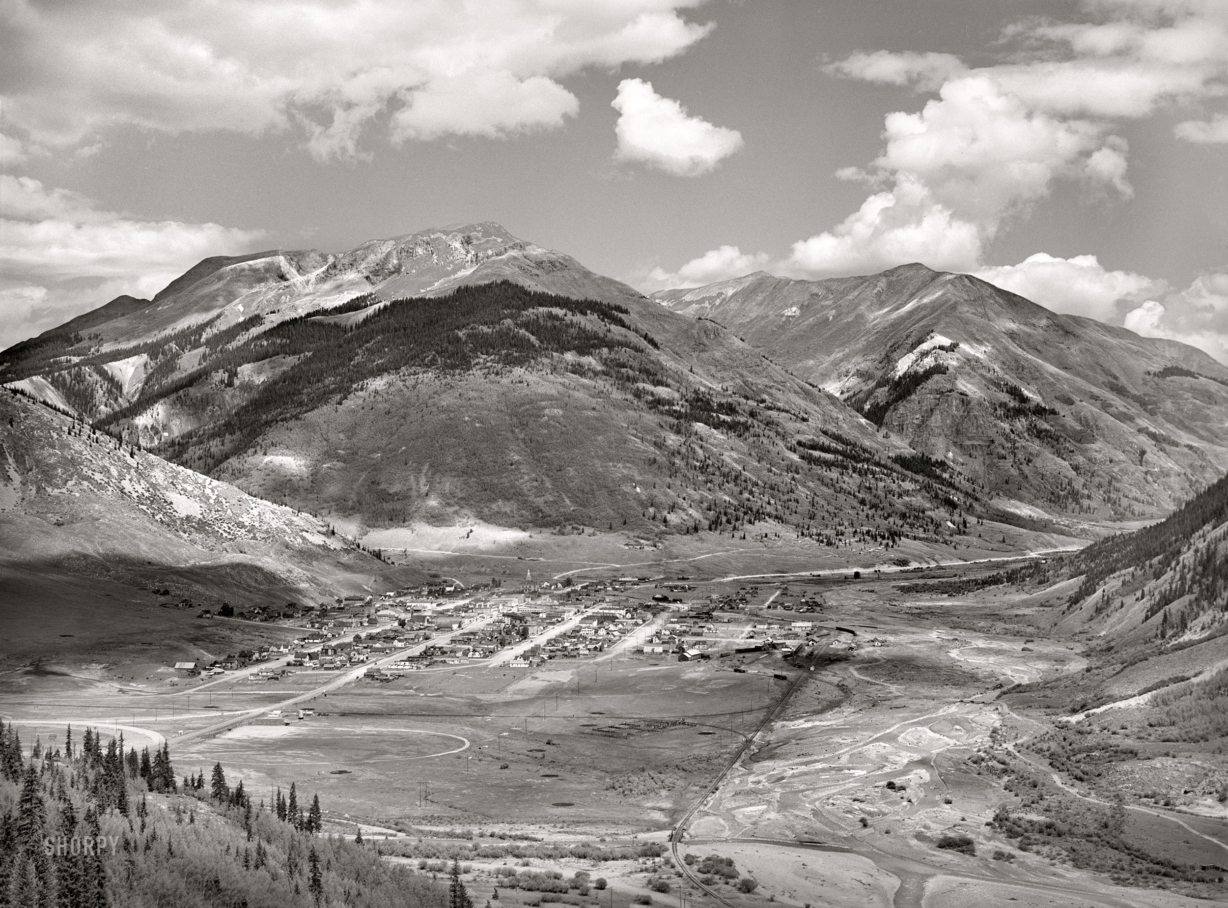 September 1940. "Silverton, Colorado, lies in a valley at 9,400 feet elevation. This has been a center for mining and milling operations, and the tailing-choked Animas River can be seen at right." Acetate negative by Russell Lee for the Farm Security Administration. View full size.
