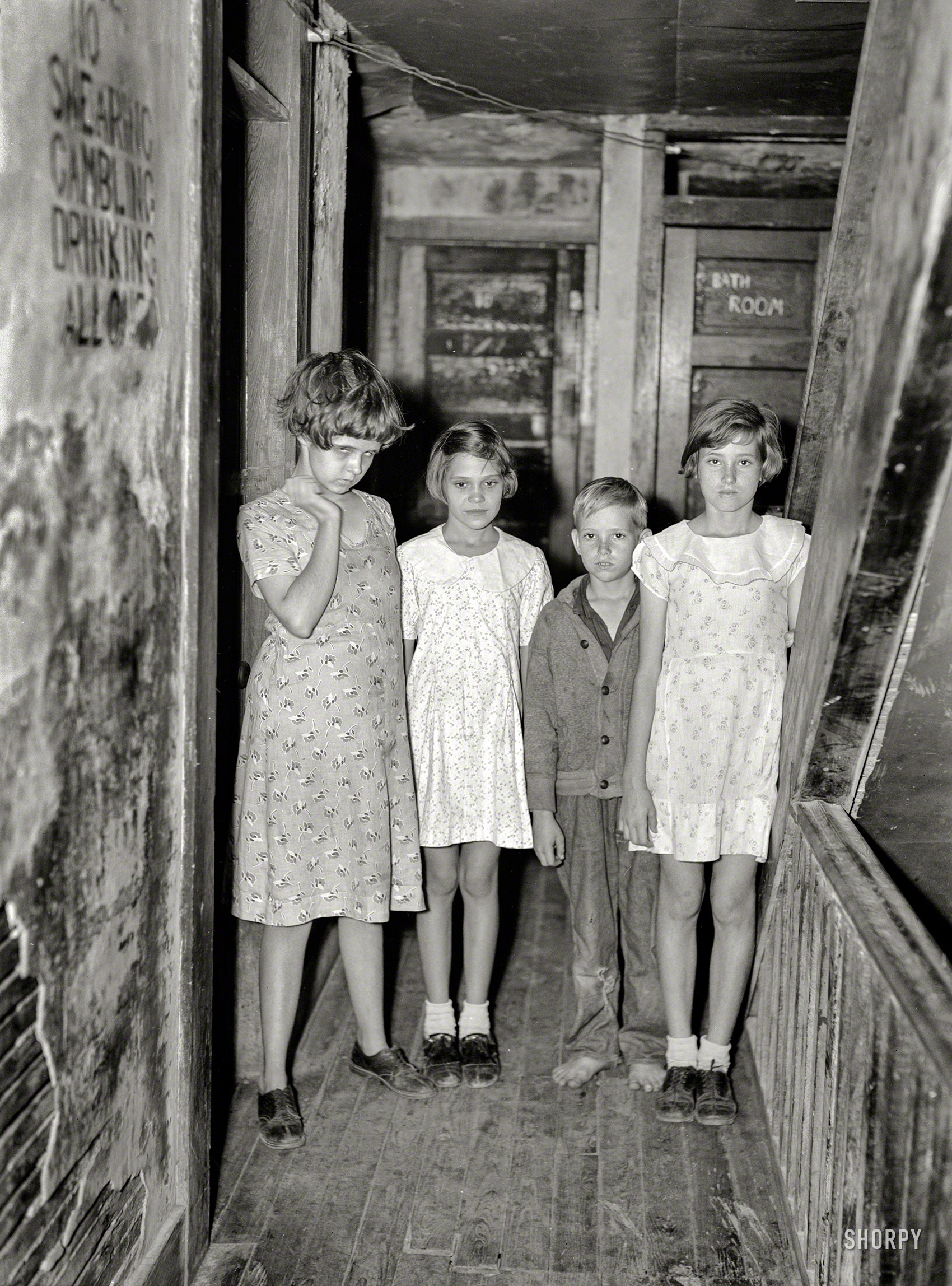 January 1937. "Children of citrus workers in hallway of apartment house. Winter Haven, Fla." Swearing, Gambling and Drinking, with their little brother Allowed. Photo by Arthur Rothstein, Resettlement Administration. View full size.