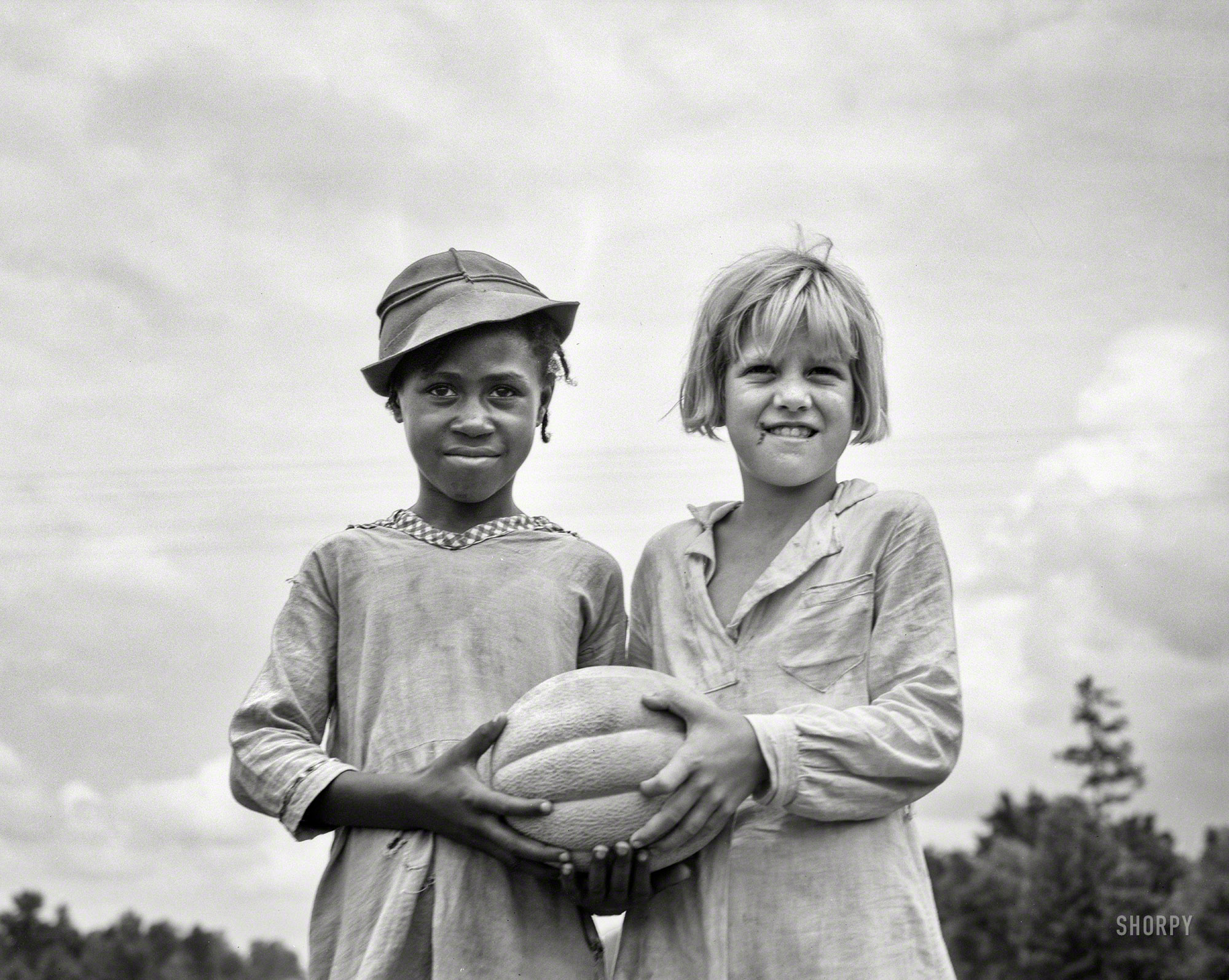 July 1936. "Hillhouse, Mississippi. Girls with food for Fourth of July celebration at Delta Cooperative Farm settled by evicted sharecroppers from Arkansas, organized in 1935 by Sherwood Eddy, a New York writer and reformer." Photo by Dorothea Lange for the Farm Security Administration. View full size.