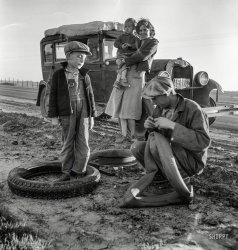 March 1937. "Migratory agricultural worker family making tire repairs along California highway U.S. 99." Photo by Dorothea Lange for the Farm Security Administration. View full size.