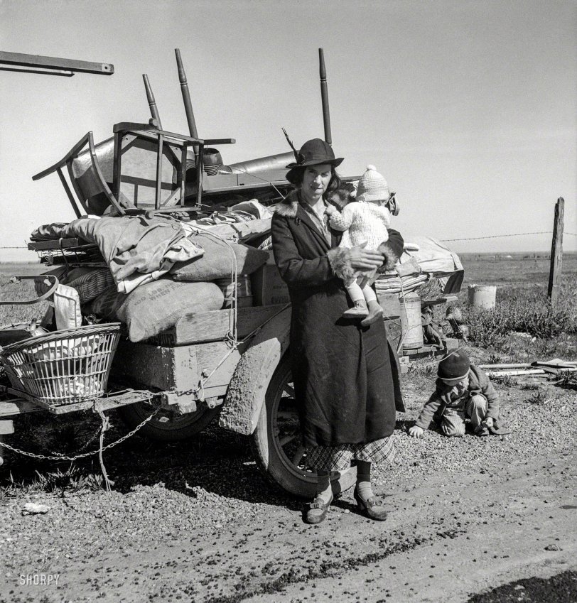February 1937. "Missouri family of five, seven months from the drought area. 'Broke, baby sick, car trouble.' U.S. 99 near Tracy, California." Last seen here. Photo by Dorothea Lange for the Resettlement Administration. View full size.
