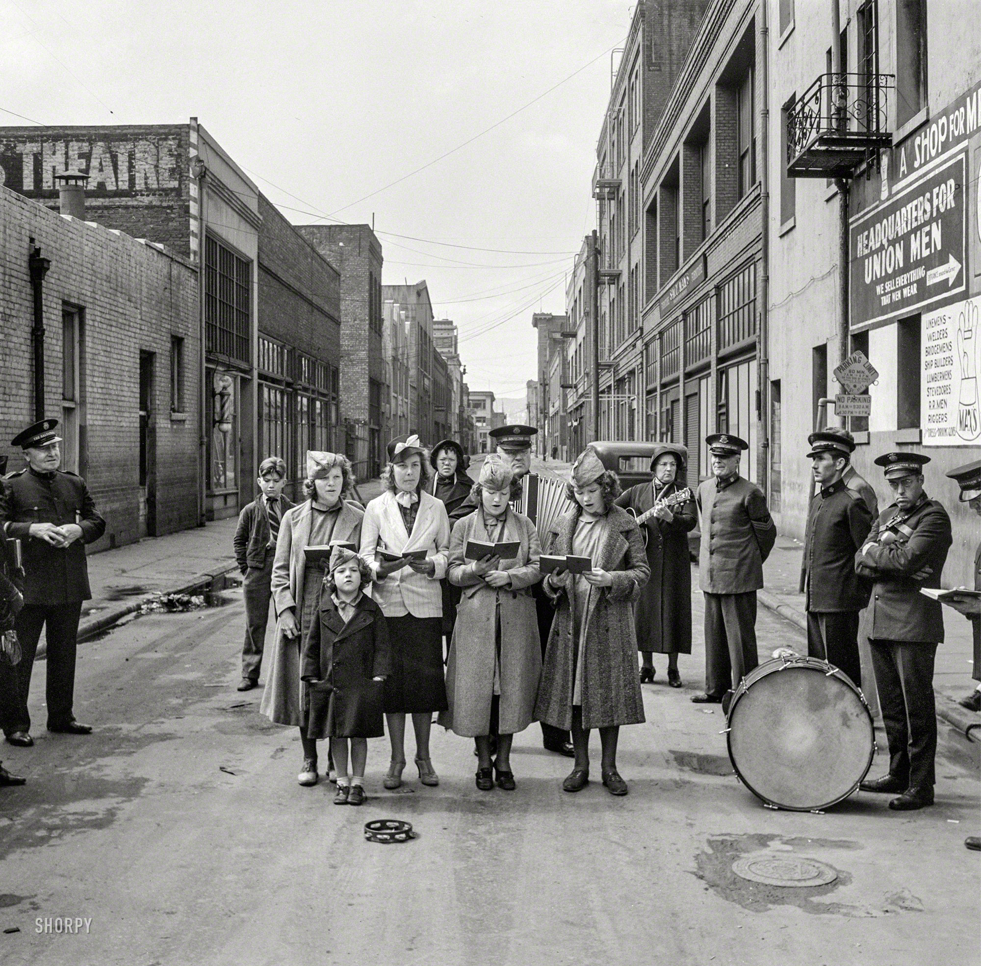April 1939. "Salvation Army, San Francisco, California. At Minna Street the army forms a semicircle, girls' Sunday school class sings between preaching to attract a crowd." Medium format negative by Dorothea Lange. View full size.