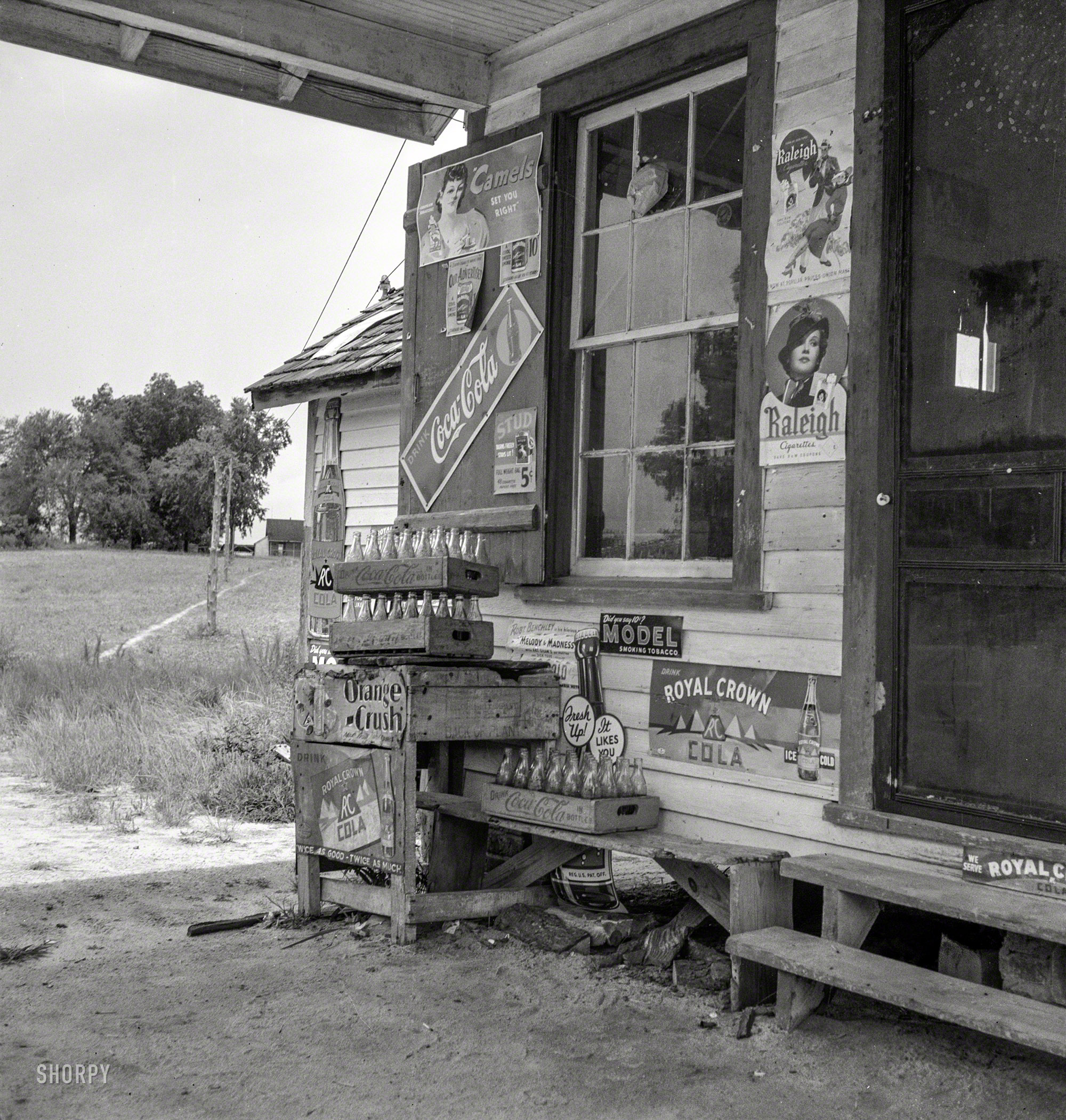 July 1939. Granville County, North Carolina. "Country filling station owned and operated by tobacco farmer. Such small independent stations have become meeting places and loafing spots for neighborhood farmers in their off times." Photo by Dorothea Lange for the Farm Security Administration. View full size.