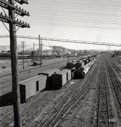 August 1939. "Centralia, Lewis County, Washington state. Railroad yard, looking down from highway bridge. Disaster to the town: The one remaining lumber mill burned down a week before. Note smoke and wreckage." Medium format negative by Dorothea Lange for the Farm Security Administration. View full size.