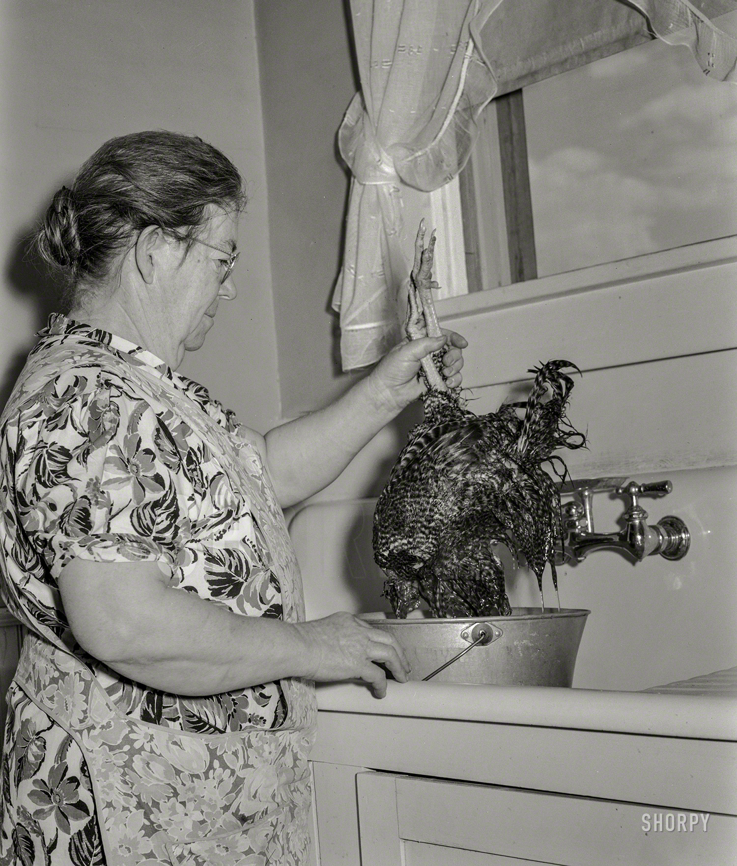 October 1939. Greeley, Colorado. "Mrs. Milton Robinson, wife of Farm Security Administration borrower, in the kitchen of her farm home." Medium format nitrate negative by Arthur Rothstein for the FSA. View full size.