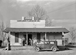January 1939. "Headquarters and general store of Sunflower Plantation, just optioned by Resettlement Administration. Near Merigold, Mississippi." Medium format nitrate negative by Russell Lee. View full size.
The plot thickens.Looks like a scene of a gangster movie.
Sunflower PlantationA pretty extensive and interesting website devoted to it, here:
https://www.sunflowerplantation.org
(The Gallery, Russell Lee, Small Towns, Stores & Markets)