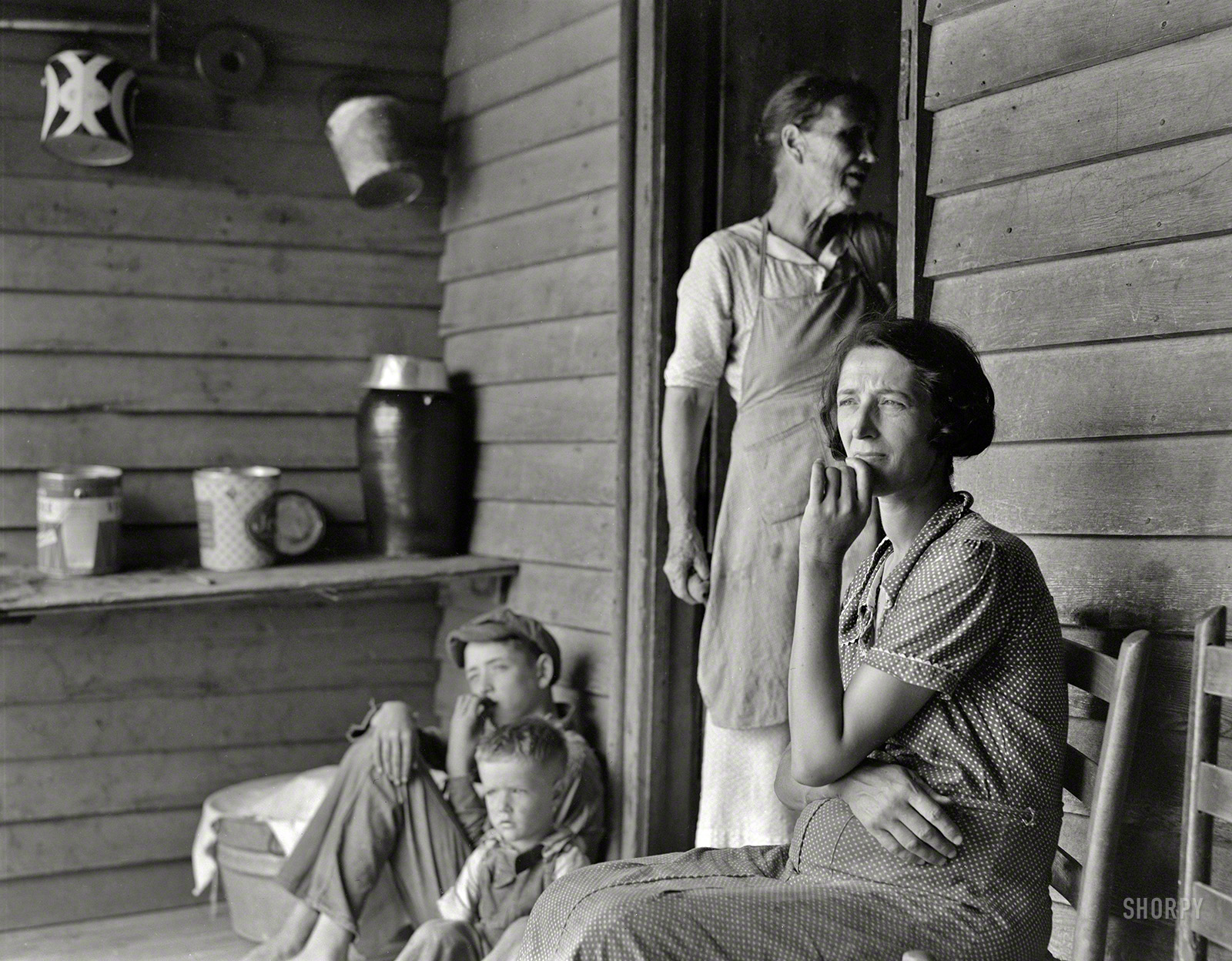 July 1937. "Sharecropper's wife, mother of seven. Woman in doorway is mother of fourteen, ten living; fifty-six grandchildren. Near Chesnee, South Carolina." Photo by Dorothea Lange for the Farm Security Administration. View full size.