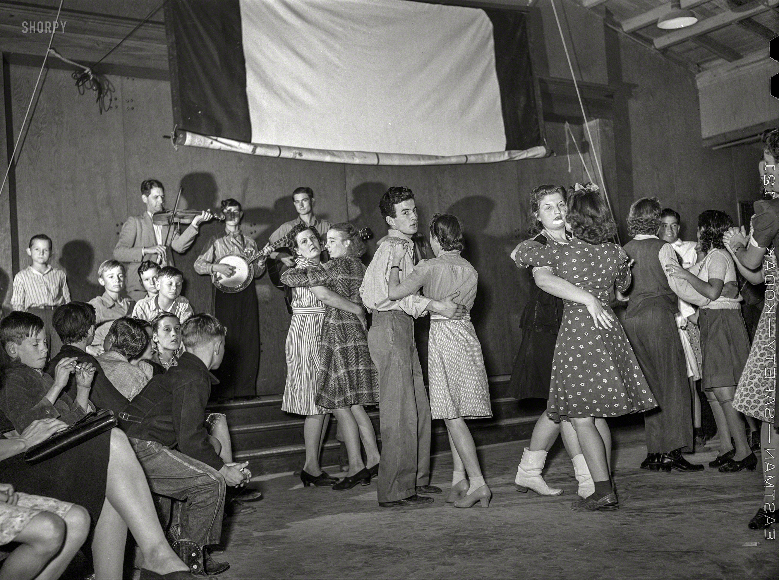 February 1942. "Farm Security Administration Mercer G. Evans camp in Weslaco, Texas. Drake family playing for a Saturday night dance." Medium format negative by the under-appreciated Arthur Rothstein. View full size.