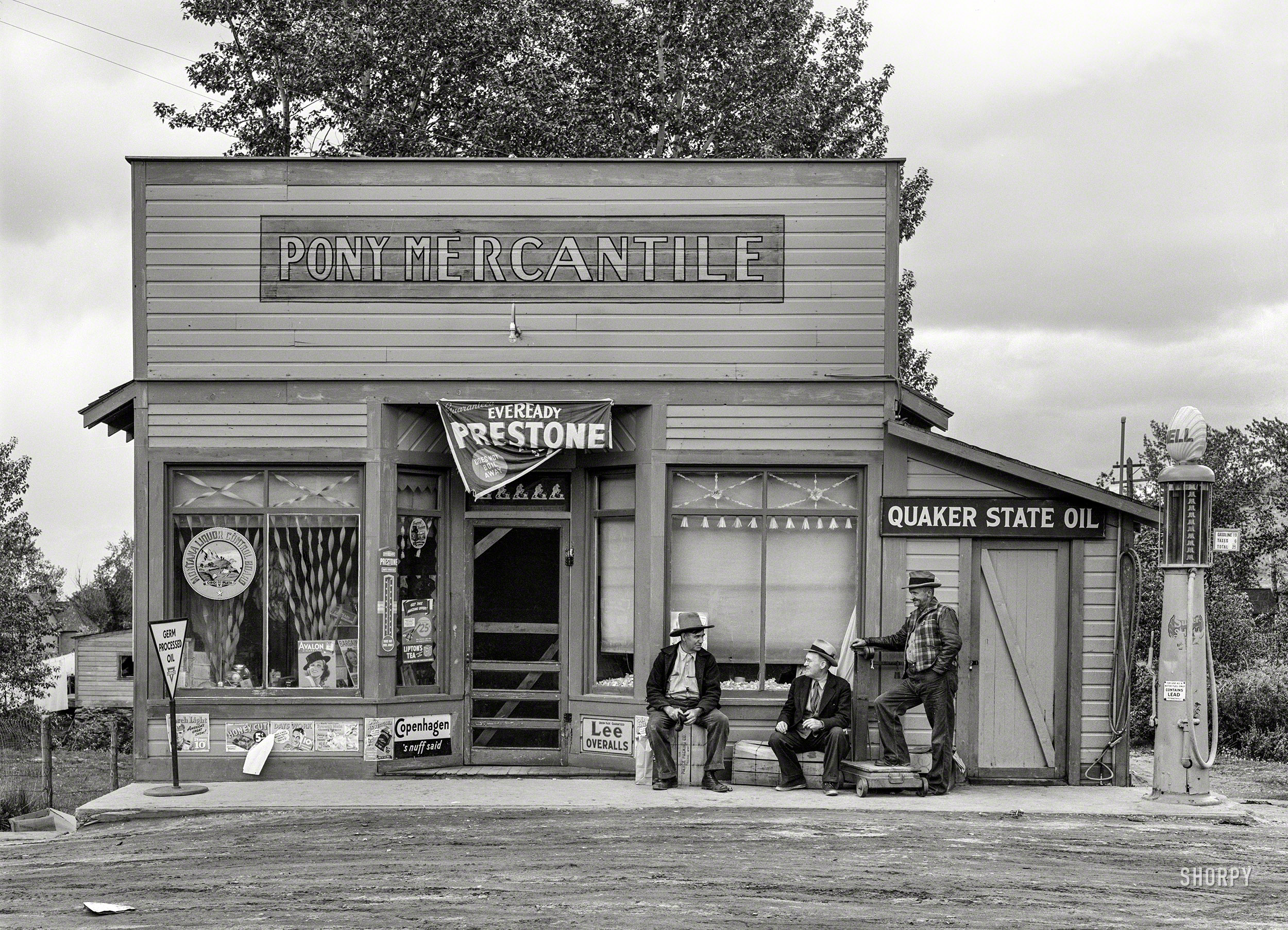 June 1939. "General store in Pony, Montana." Back when the brands on stallions, bulls and heifers migrated to the gas station. Medium format negative by Arthur Rothstein for the Farm Security Administration. View full size.