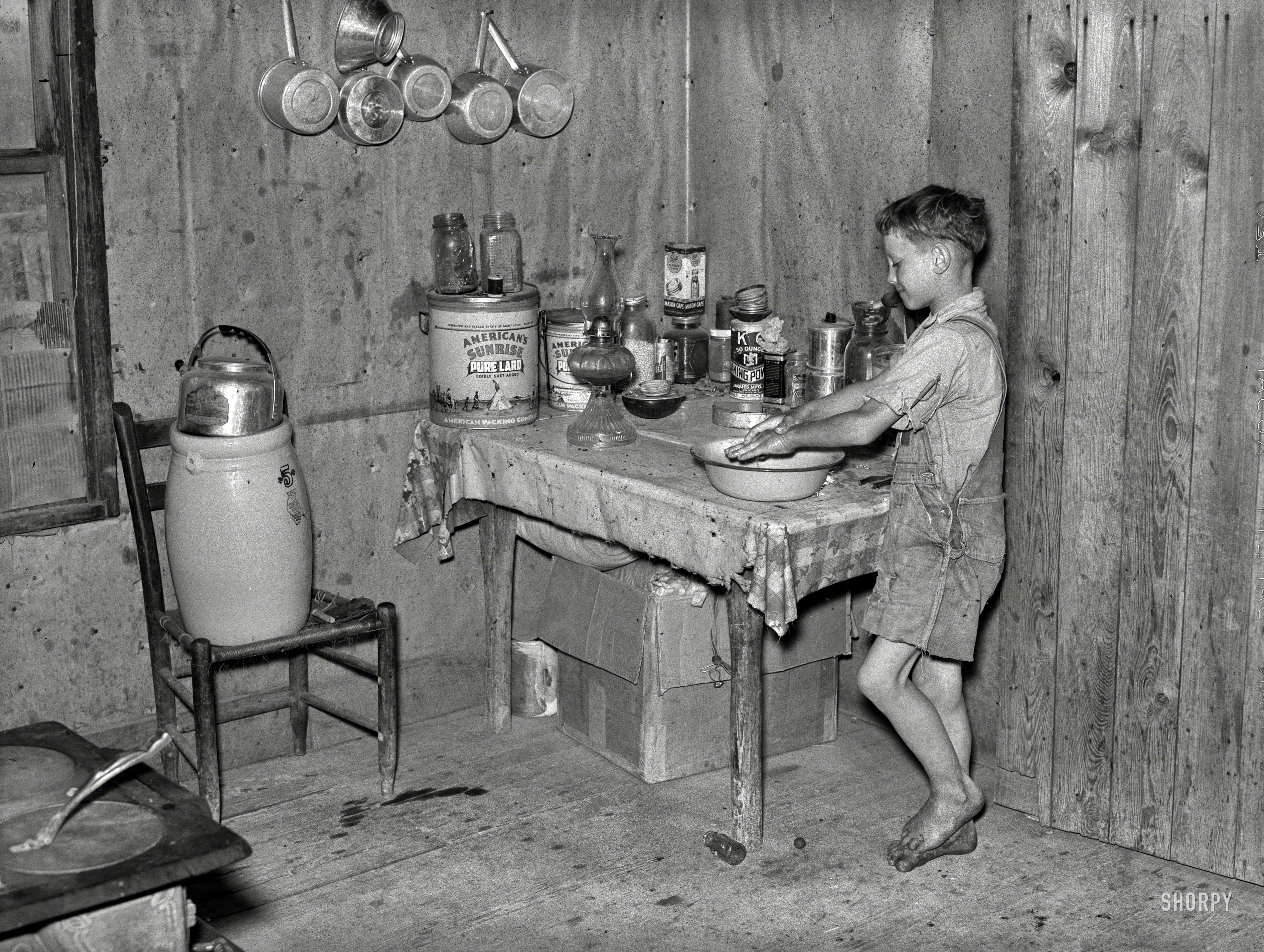 May 1938. "Southeast Missouri Farms. Son of sharecropper washing hands." Our title for this photo comes from the things in this photo. Medium format negative by Russell Lee for the Farm Security Administration. View full size.