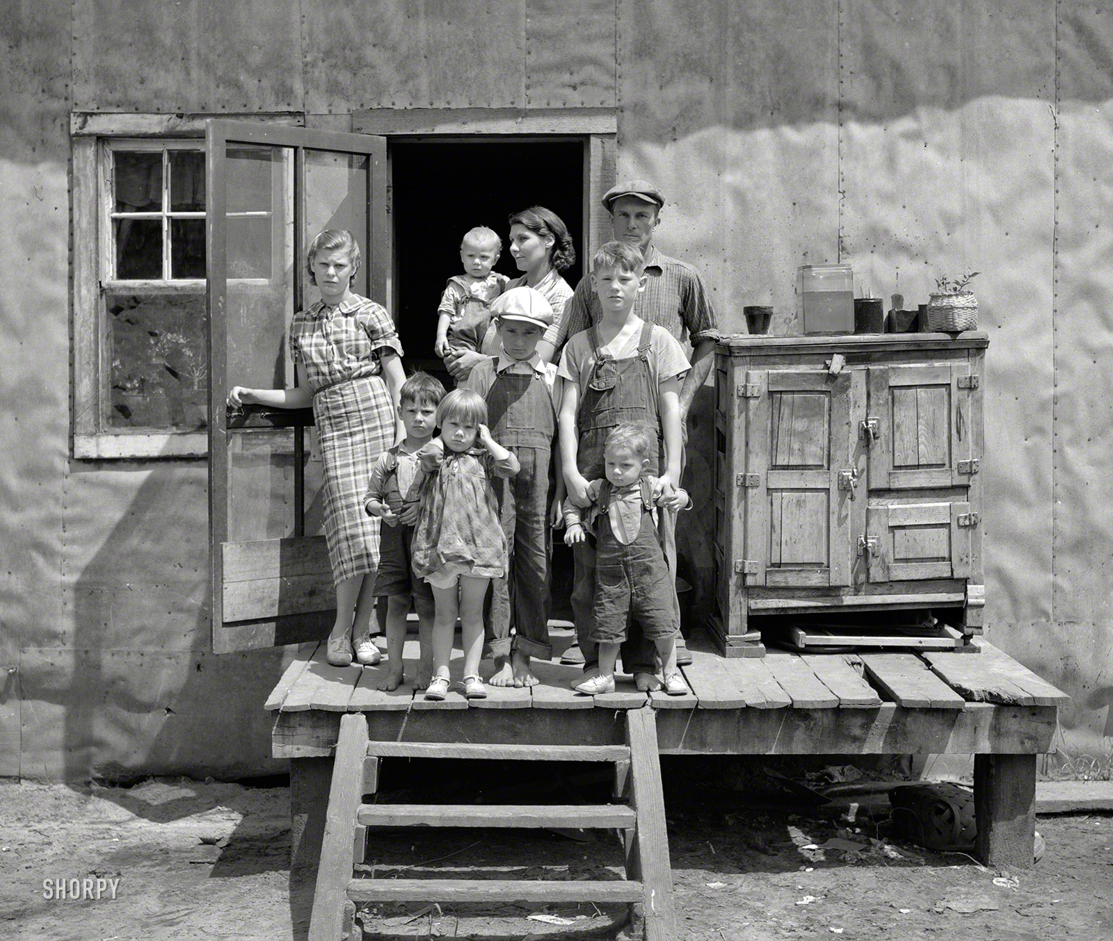 &nbsp; &nbsp; &nbsp; &nbsp; Black River Falls (vicinity), Wisconsin. April-June 1937. Photographs show families who live on small farms in cut-over areas. Dilapidated log cabins and shacks; interior details. Poor families; Bohemian farm families. Few scenes in town.
June 1937. "Ray Allen family near Black River Falls, Wisconsin." Medium format negative by Russell Lee for the Resettlement Administration. View full size.